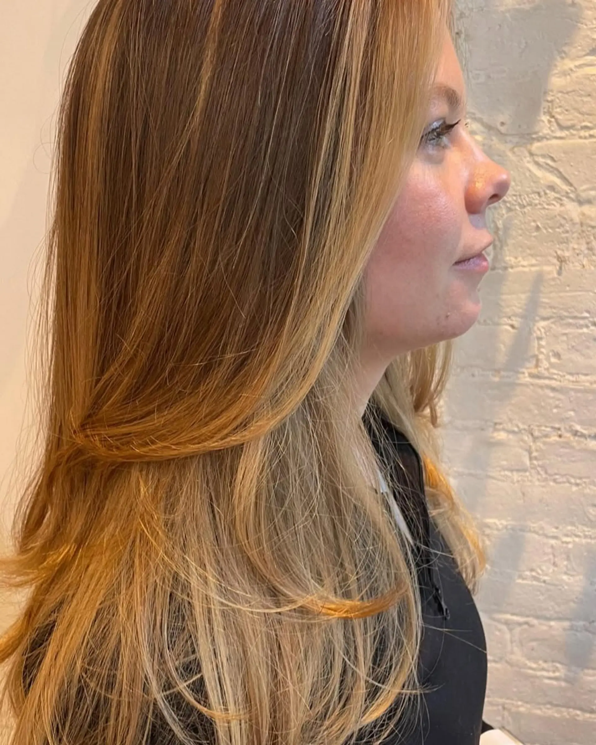 Long layered hairstyle with honey blonde balayage. 2