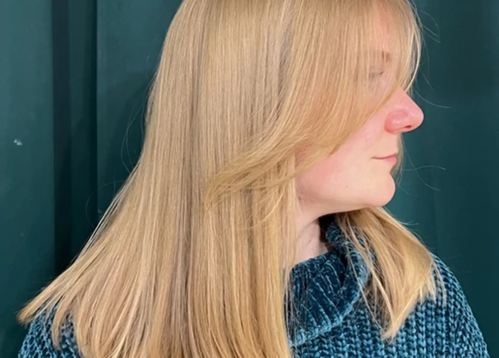 A long, straight blonde hairstyle with soft layers and side-swept bangs, featuring a natural luster and smooth finish. 1