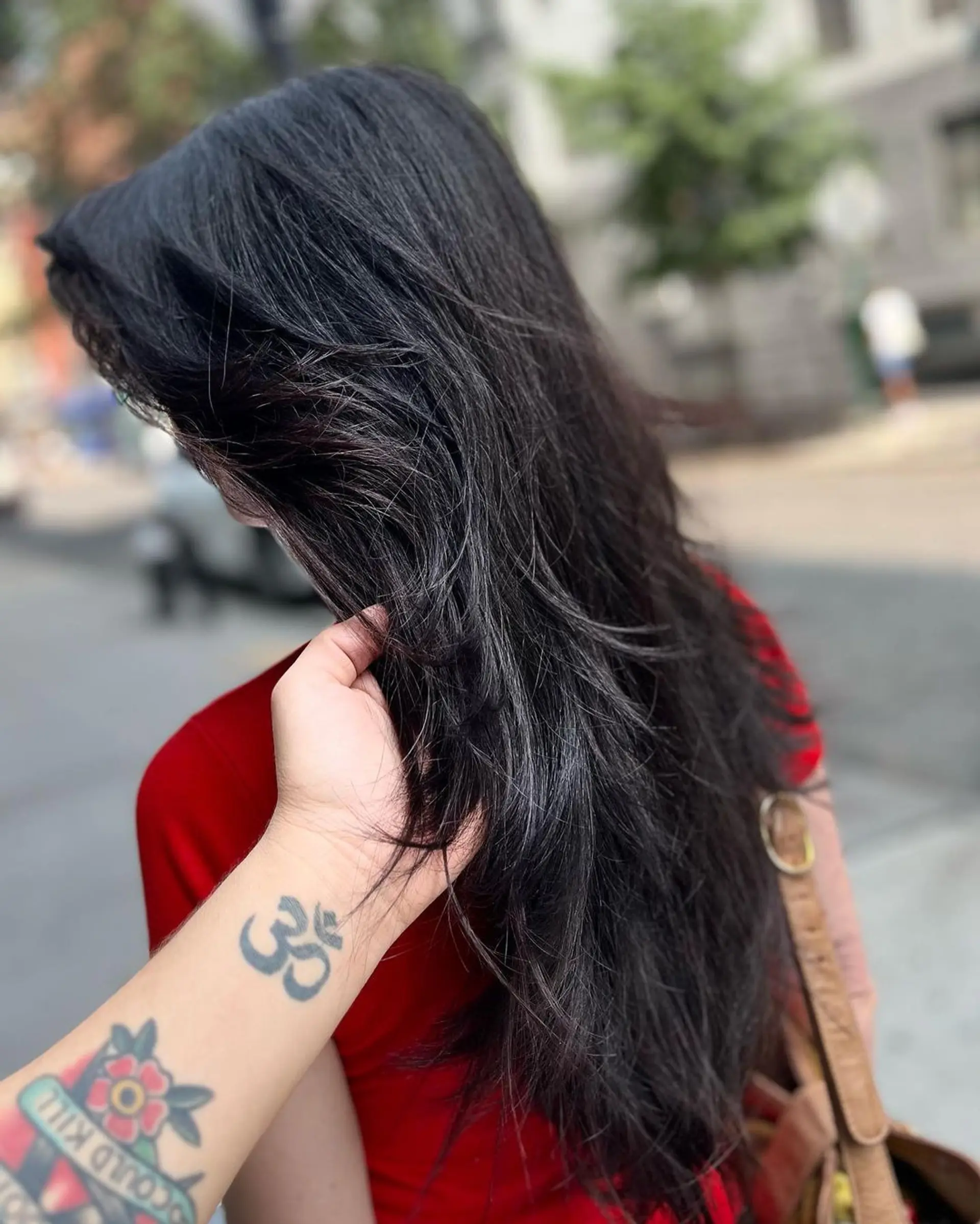 Long, straight, black hair with a lustrous finish, layered ends, and side-swept locks. 2