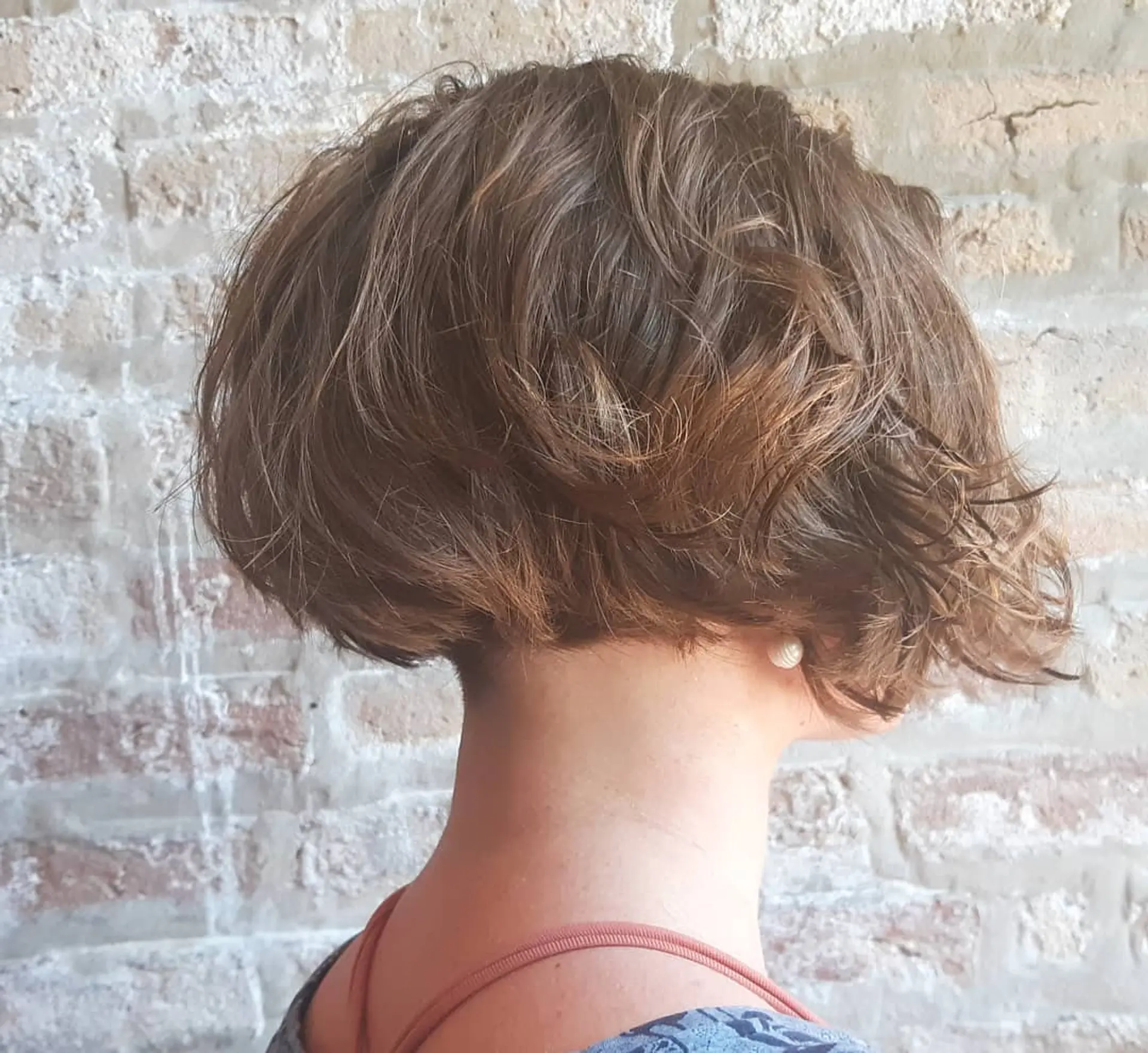 A textured and layered inverted bob, shorter in the back and slightly longer towards the front. 1