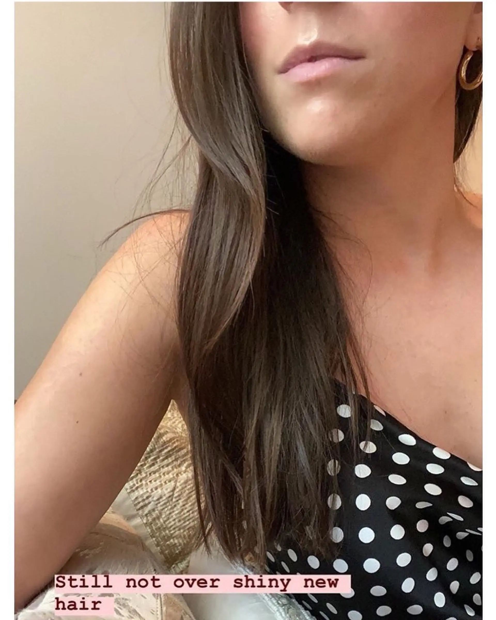 Smooth, long brunette hair draped over the shoulder with a soft, healthy shine and clean ends. 1