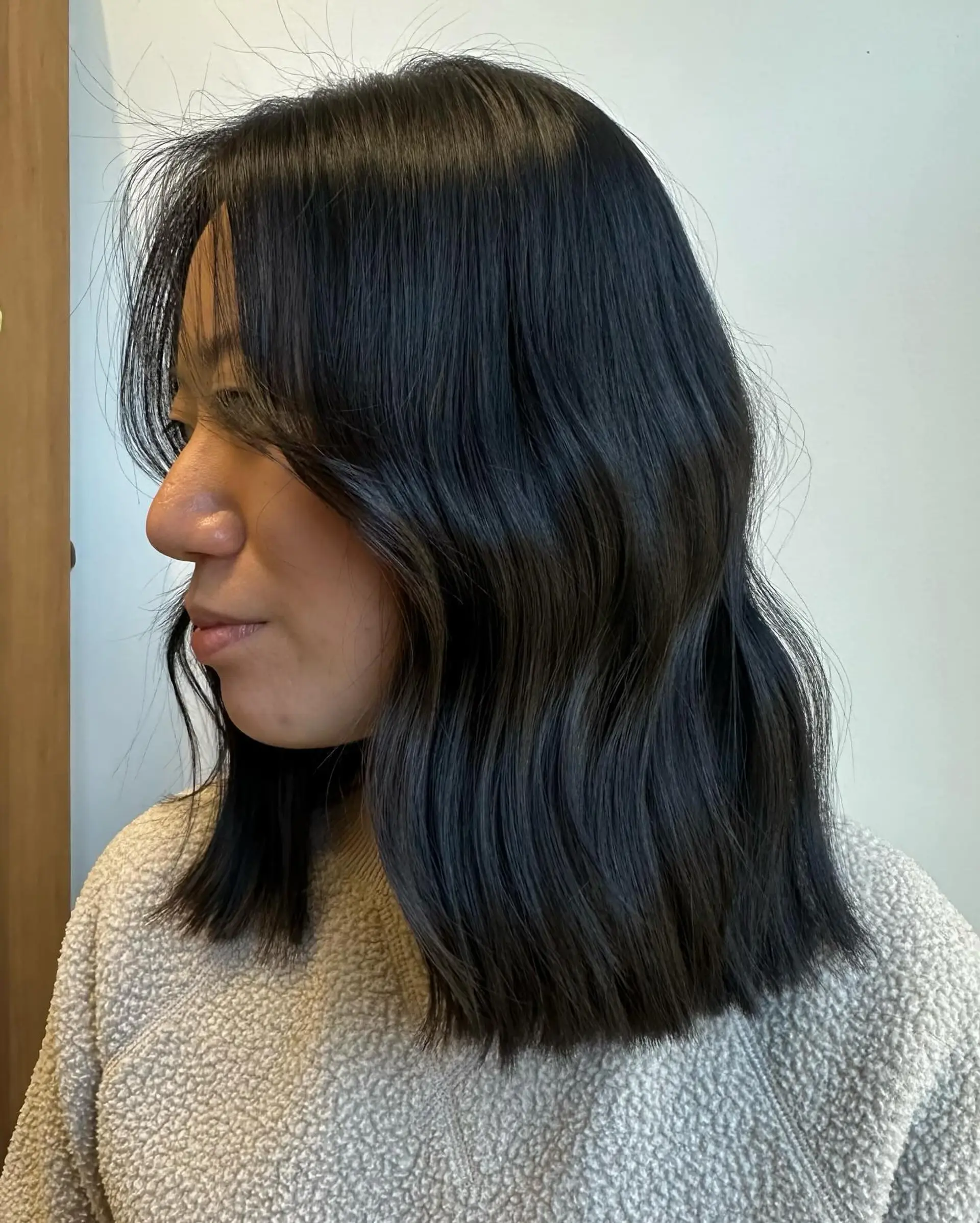 A shoulder-length layered lob with a slight wave. 1
