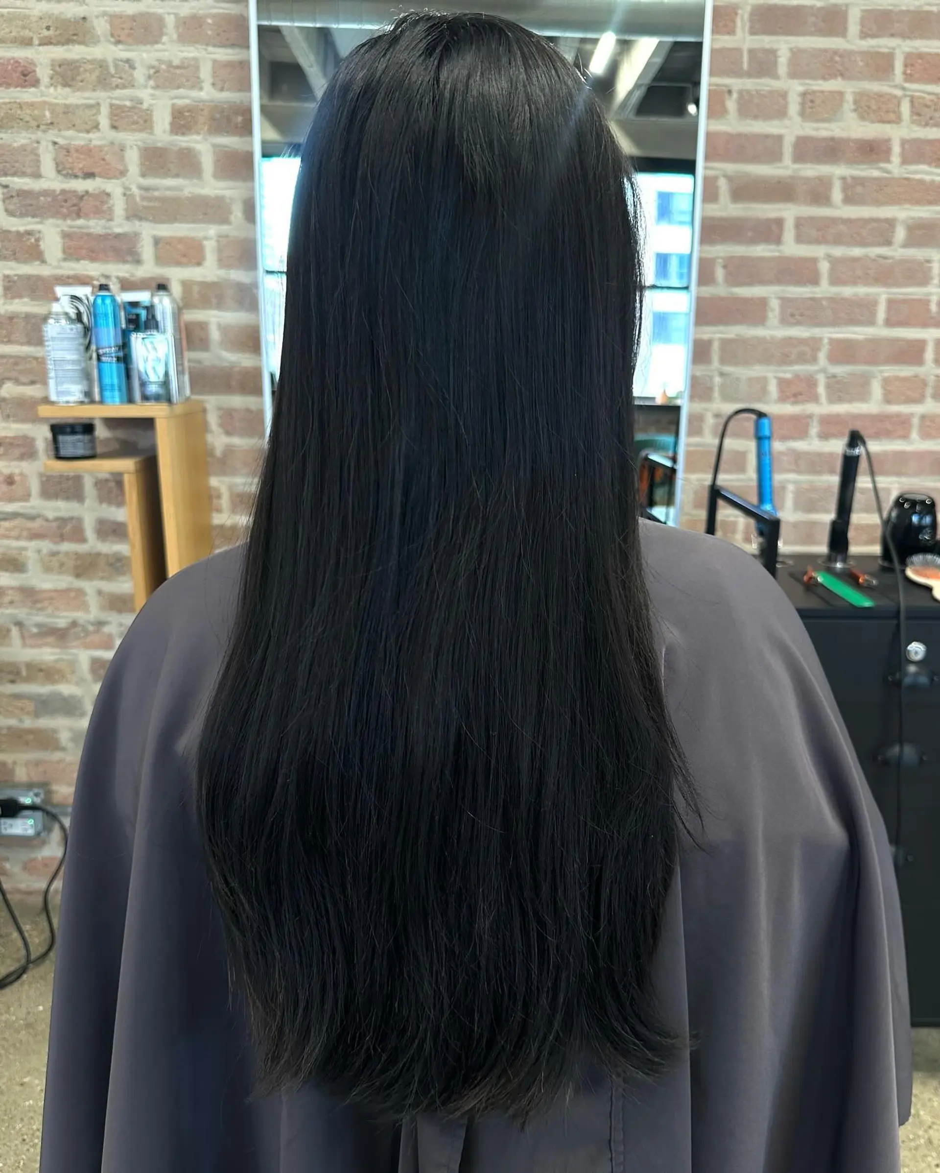 A shoulder-length layered lob with a slight wave. 2
