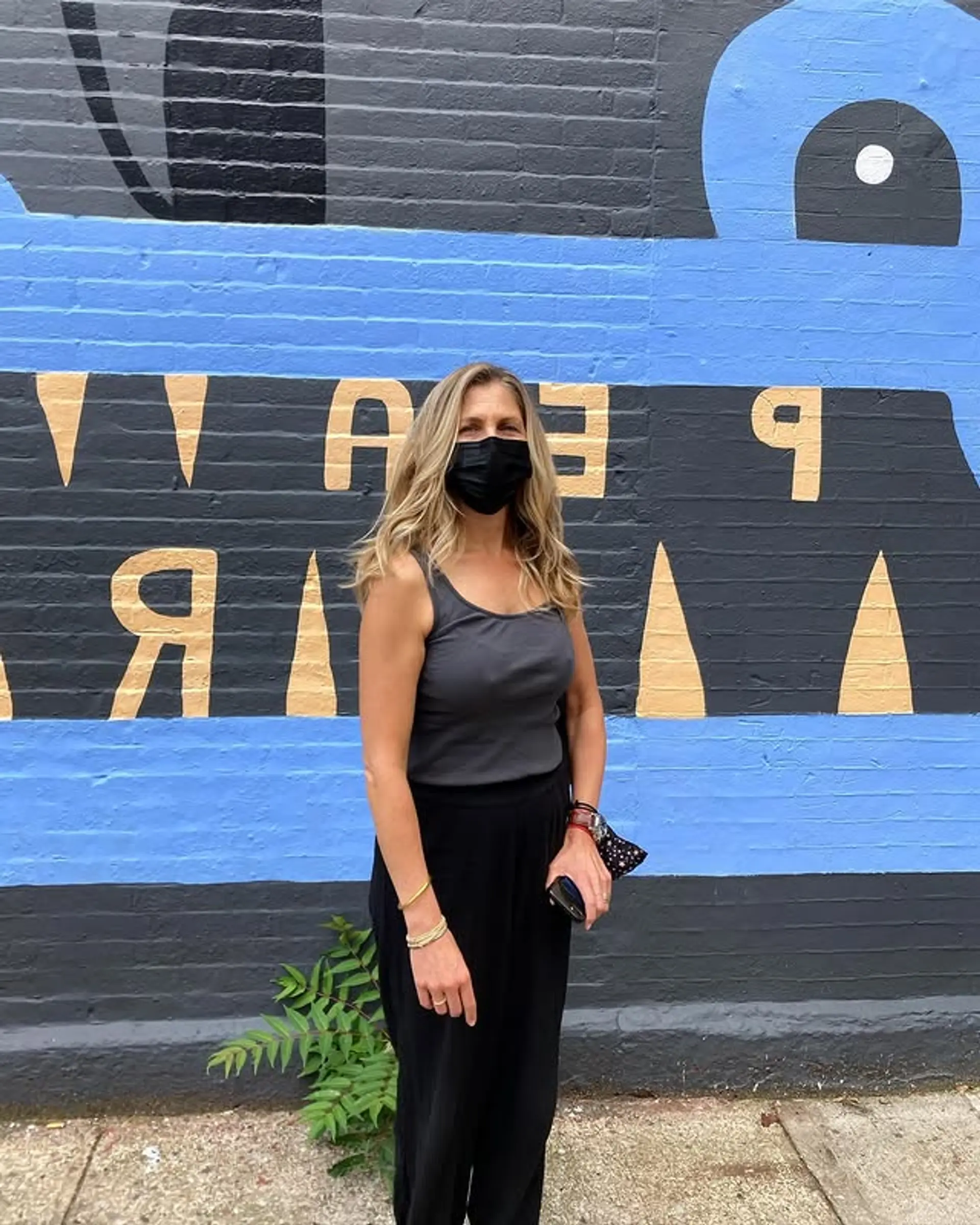 This hairstyle features medium length wavy hair with subtle layering for a relaxed, beachy look. 1