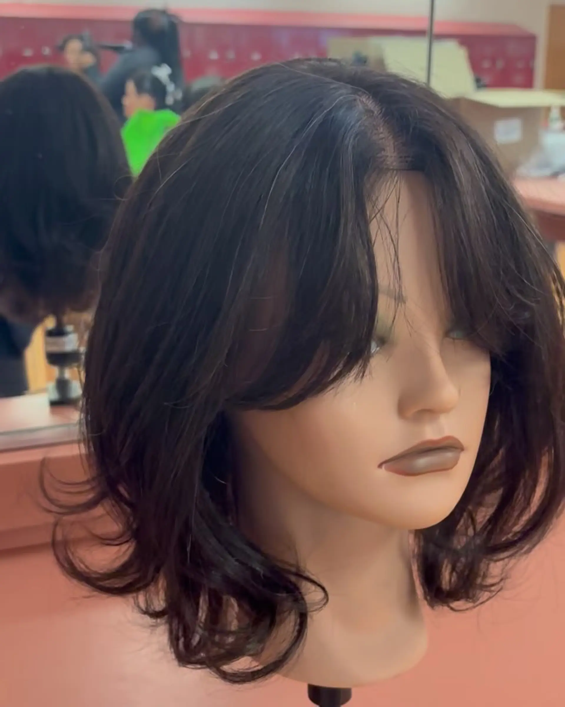 Medium-length dark brown layered cut styled with a voluminous blowout, flipped-out ends, and curtain bangs. 1