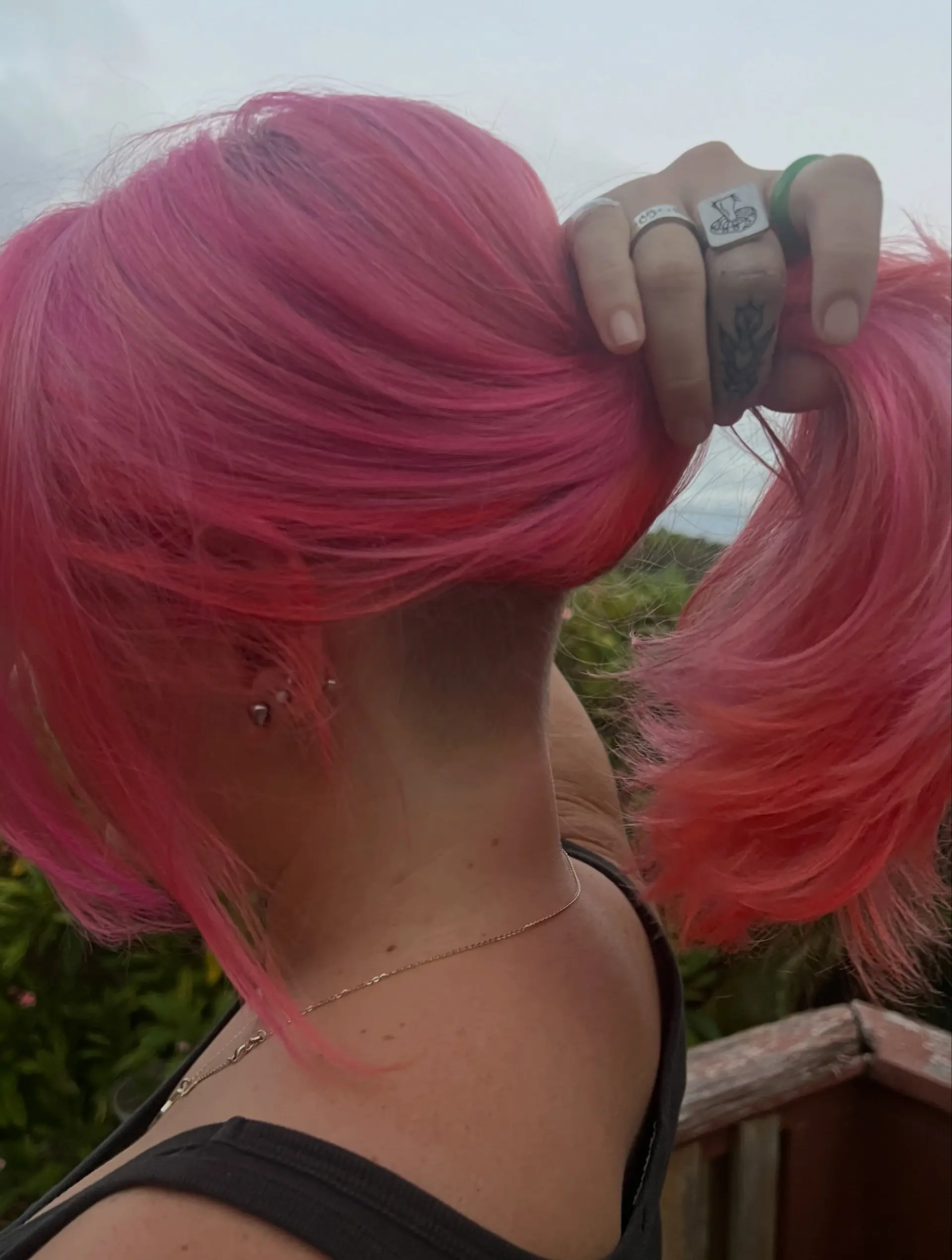 Vibrant hot pink medium-length hair featuring a shaved nape undercut. 1