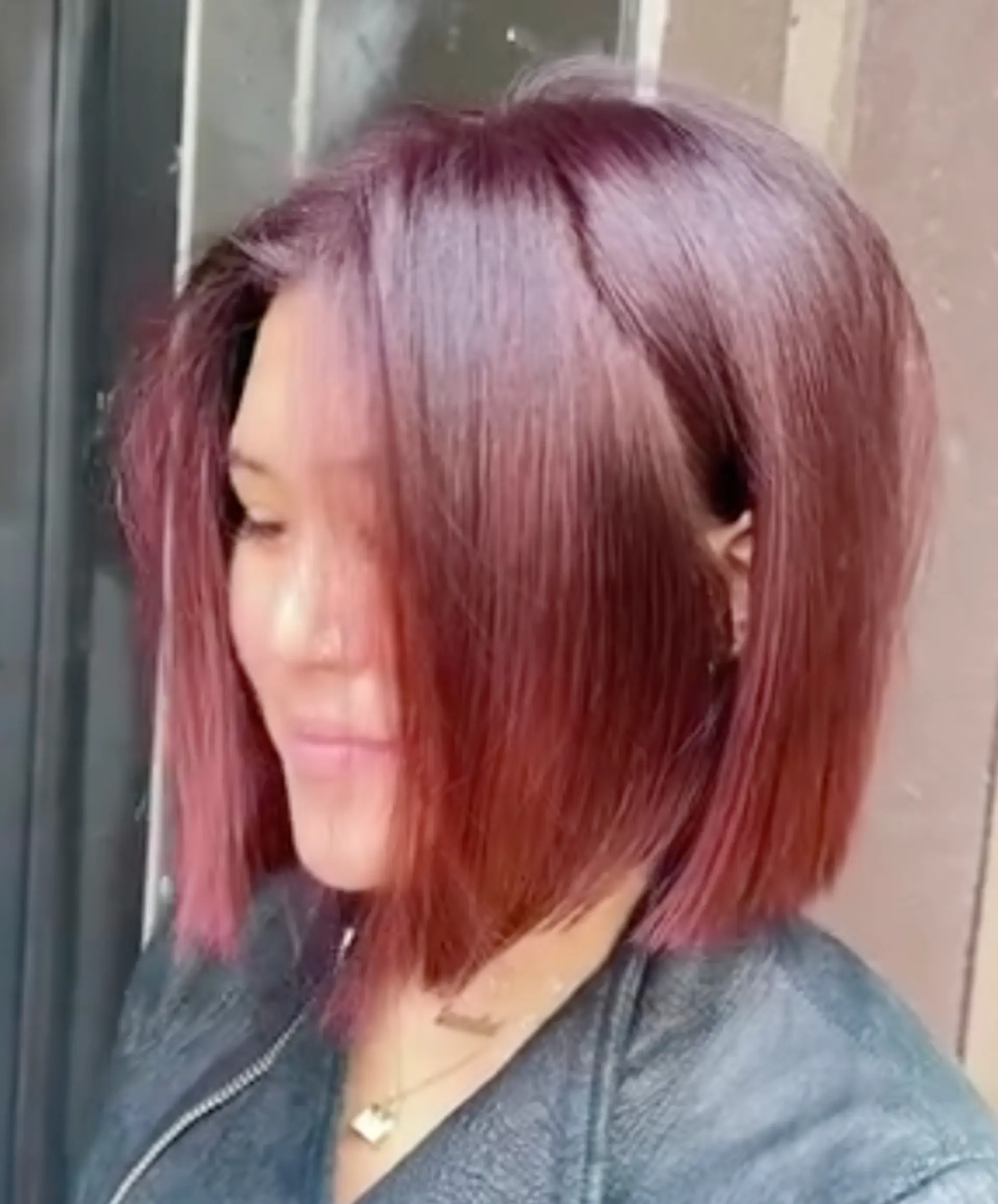A sleek, chin-length blunt bob with sharp, straight edges and vibrant magenta-toned hair color. 1