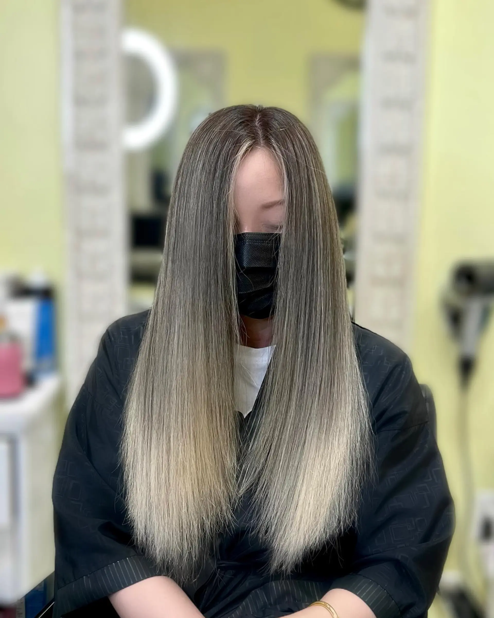 Long, straight hair with a seamless ash brown to blonde ombre. 1