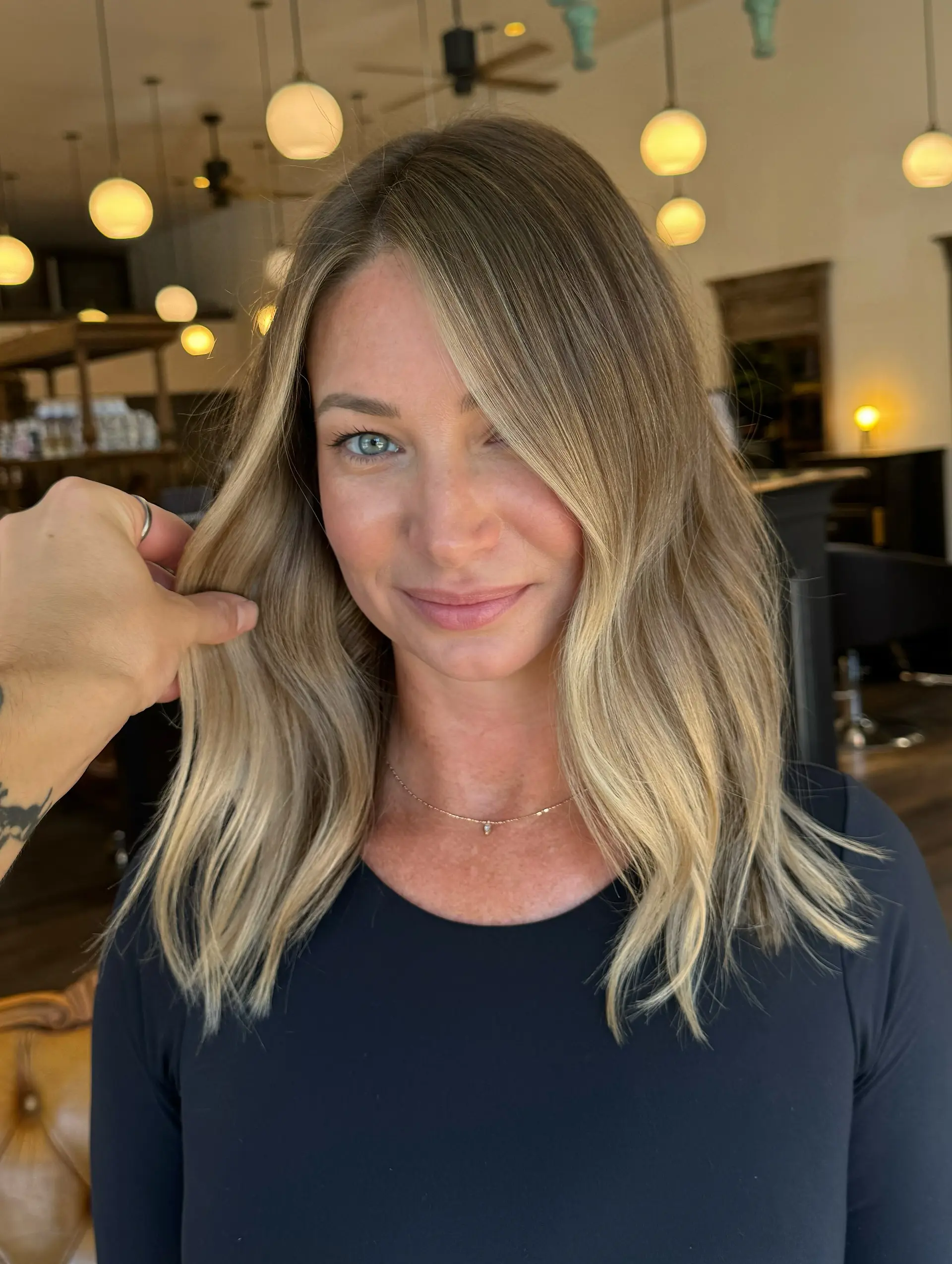 Shoulder-length textured lob with dimensional sun-kissed highlights, blended lowlights, and soft waves. 1