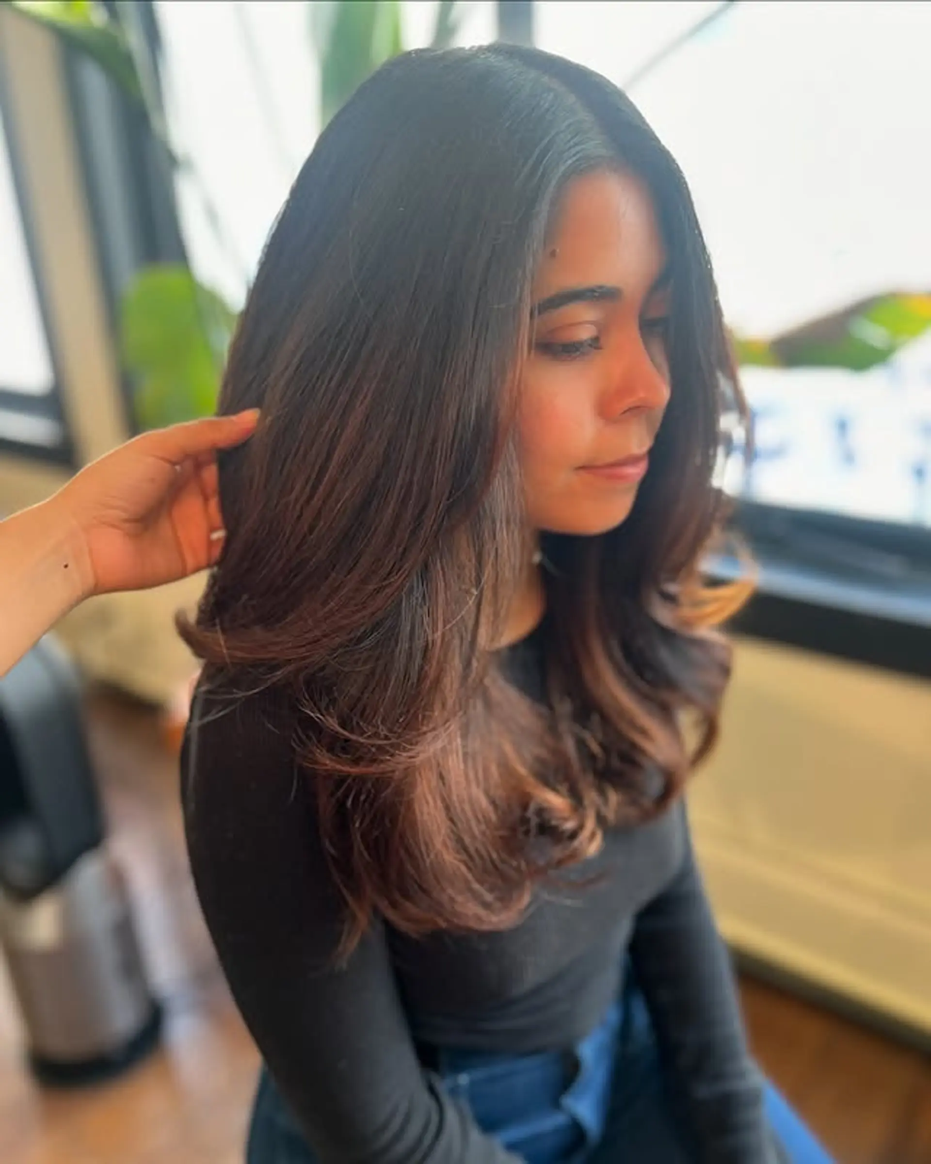 A long, layered haircut with face-framing auburn highlights. 1