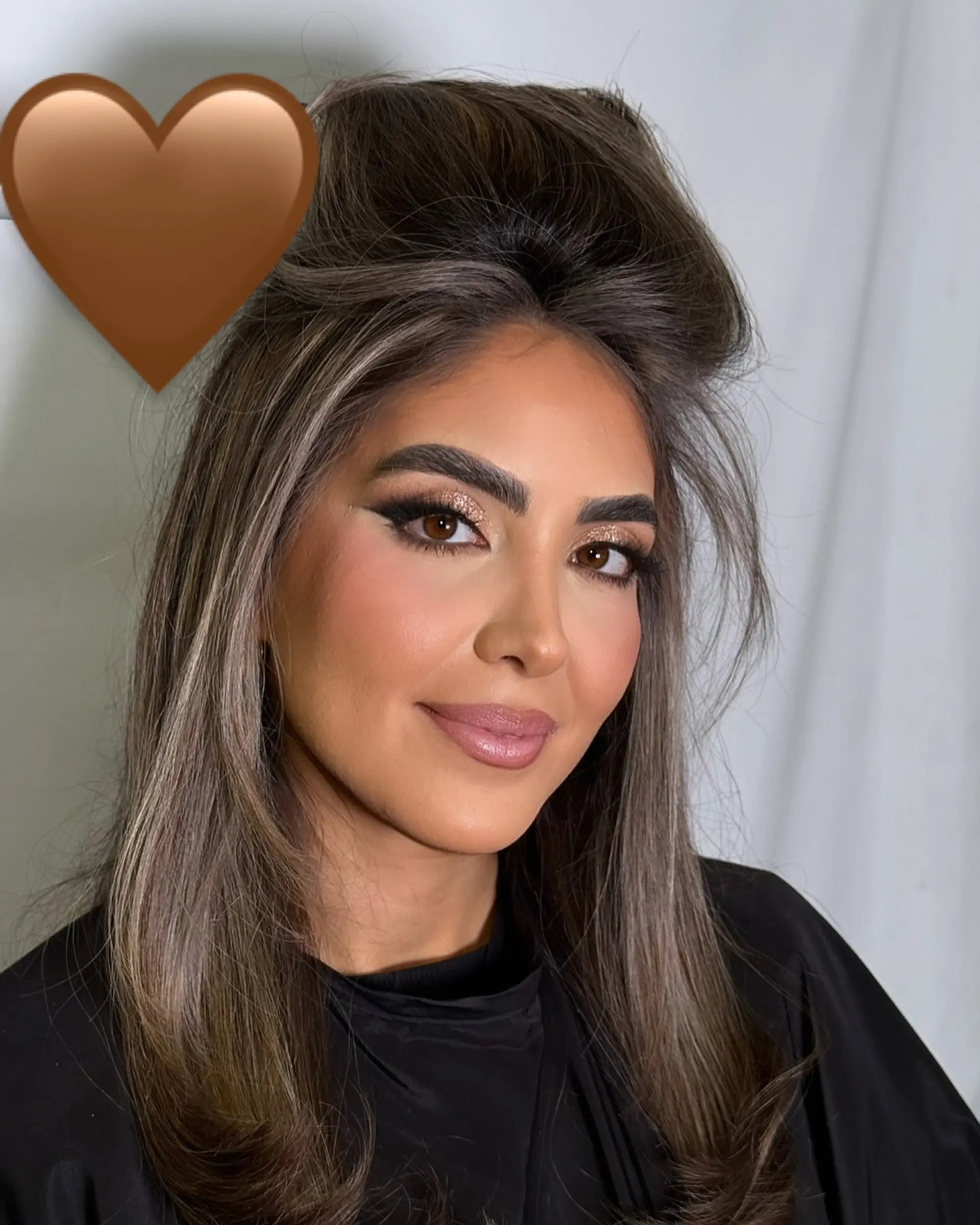 A glamorous, high-volume blowout featuring lifted roots at the crown and smooth, face-framing layers with softly curled ends. 1