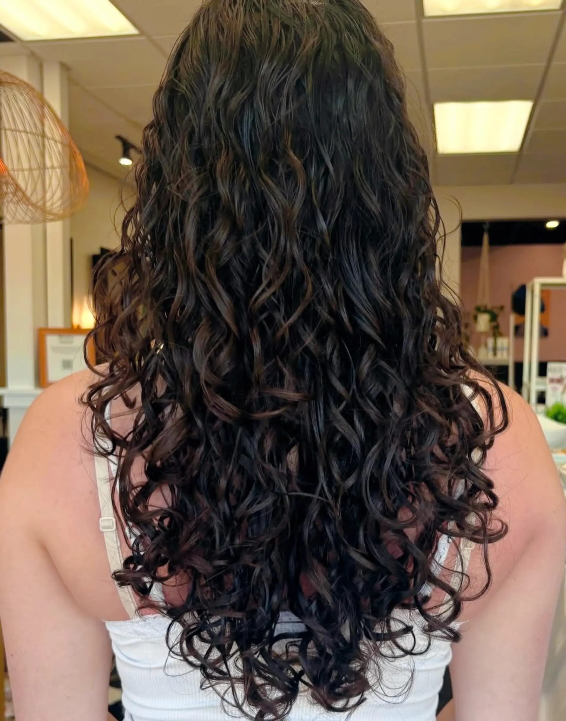 Long, dark curly hair with defined, bouncy ringlets cascading down the back. 1