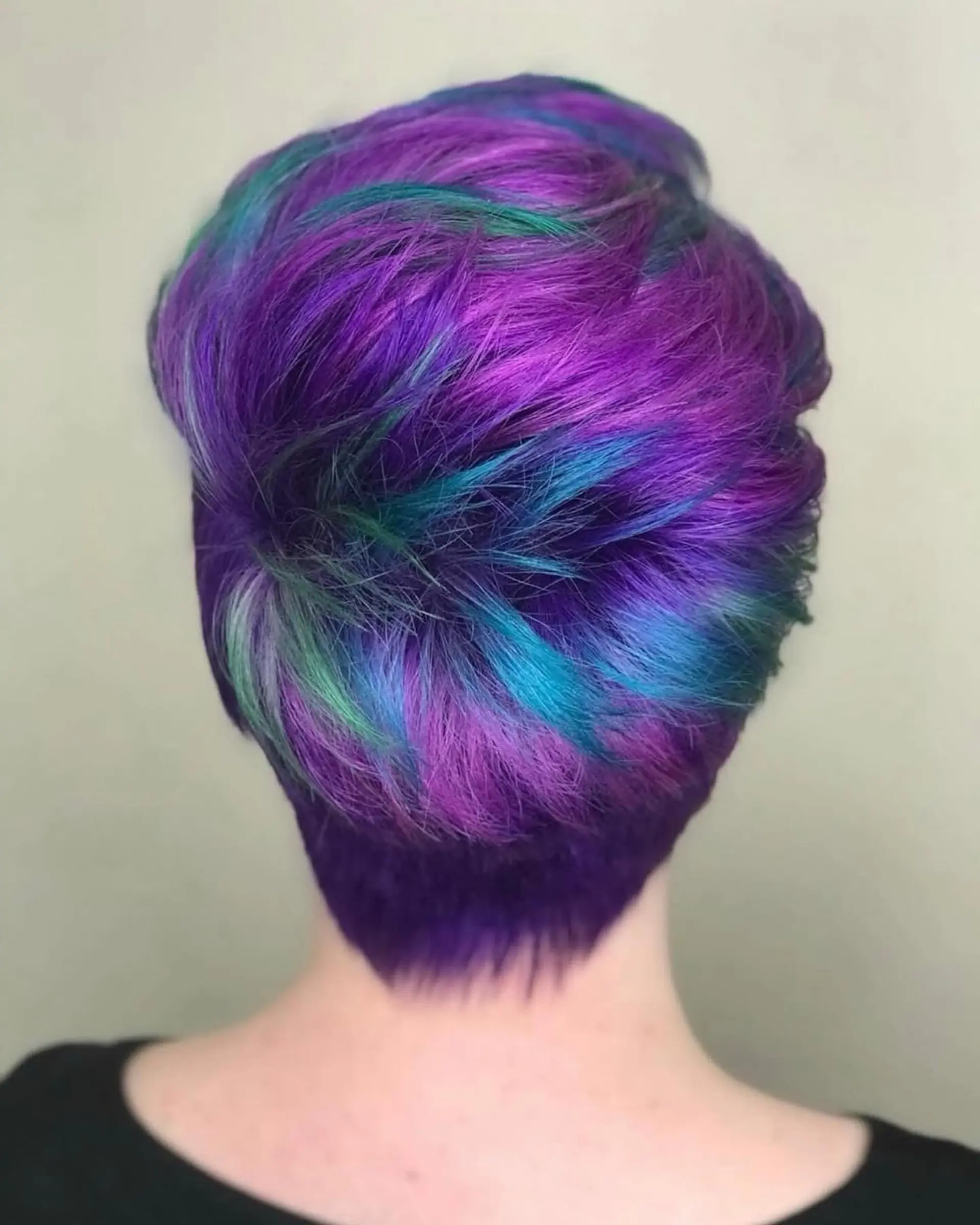 A textured short pixie cut featuring vibrant multidimensional purple, teal, and electric blue tones. 1
