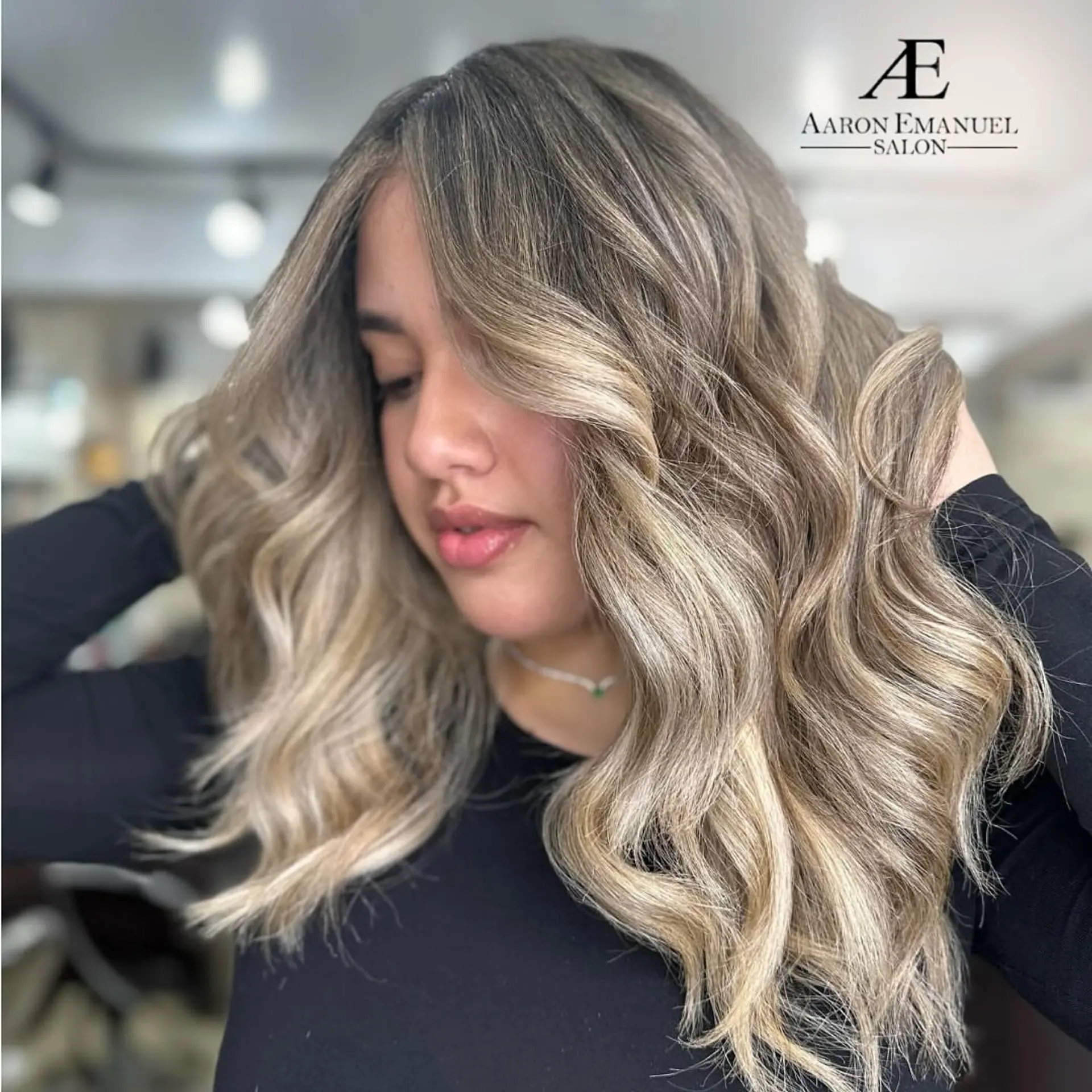 This is a medium length wavy hairstyle with a bronde balayage. 1