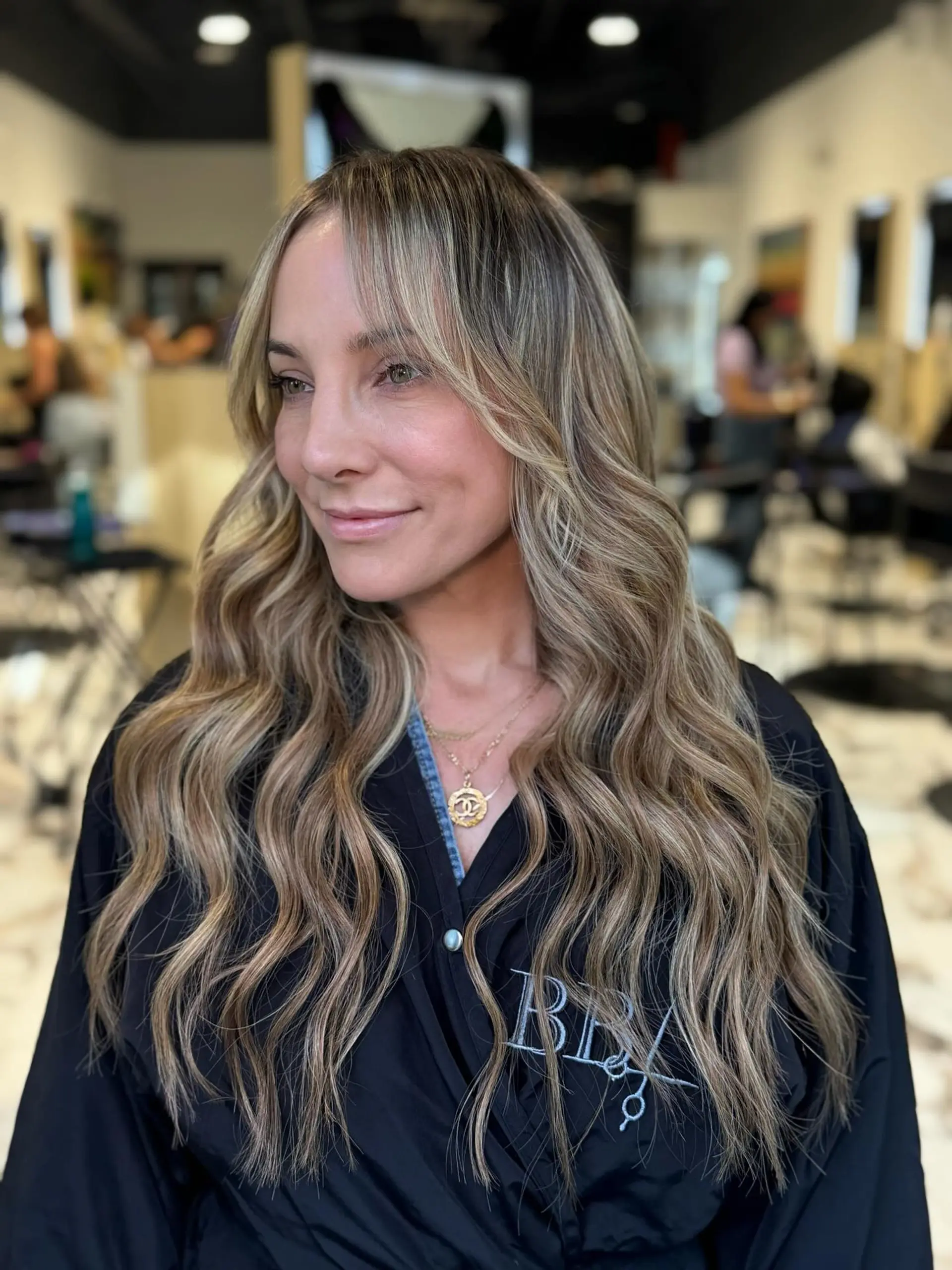Long, dimensional ash blonde waves with soft face-framing layers. 1