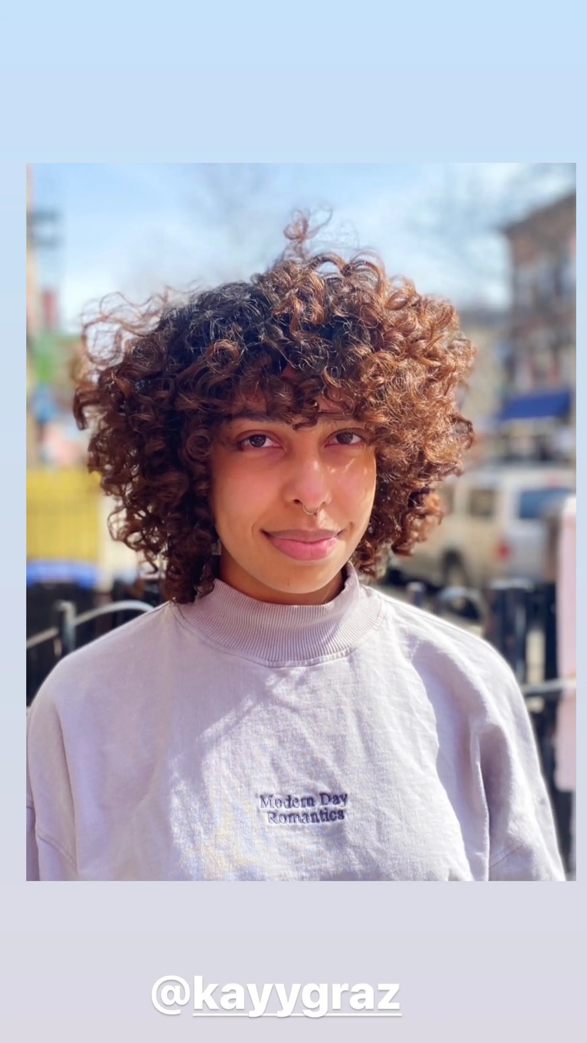 A curly shag haircut featuring textured layers for a voluminous and modern look. 1