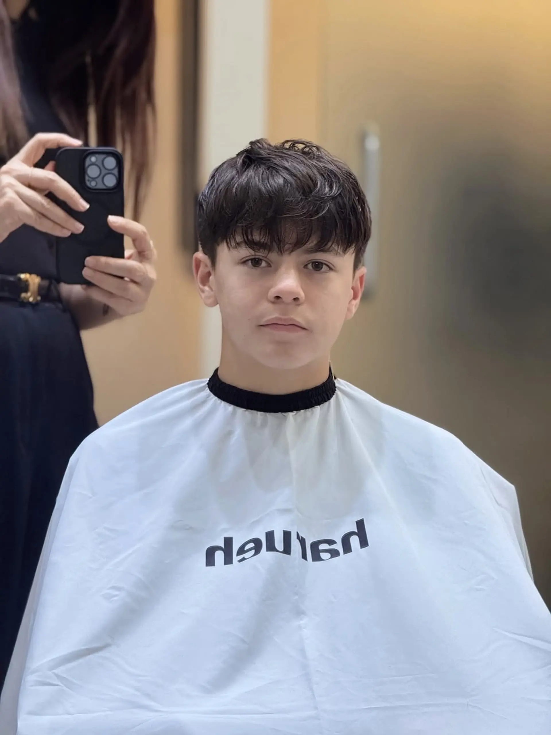 A modern textured crop with a forward-sweeping fringe and slightly tapered sides, designed to showcase natural hair texture with a messy, effortless aesthetic. 1