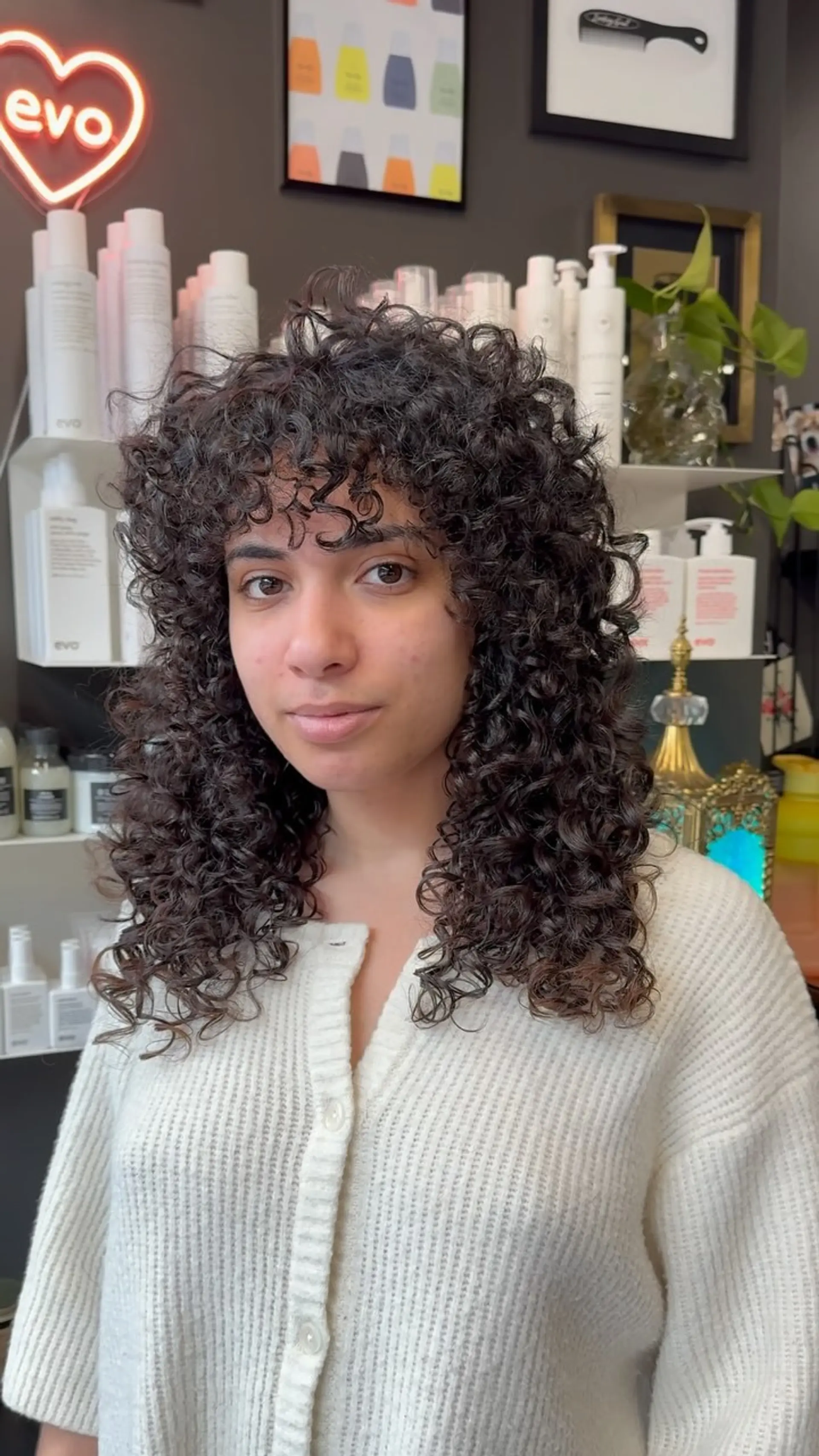 A voluminous curly shag haircut featuring defined natural ringlets and full curly fringe framing the face. 1