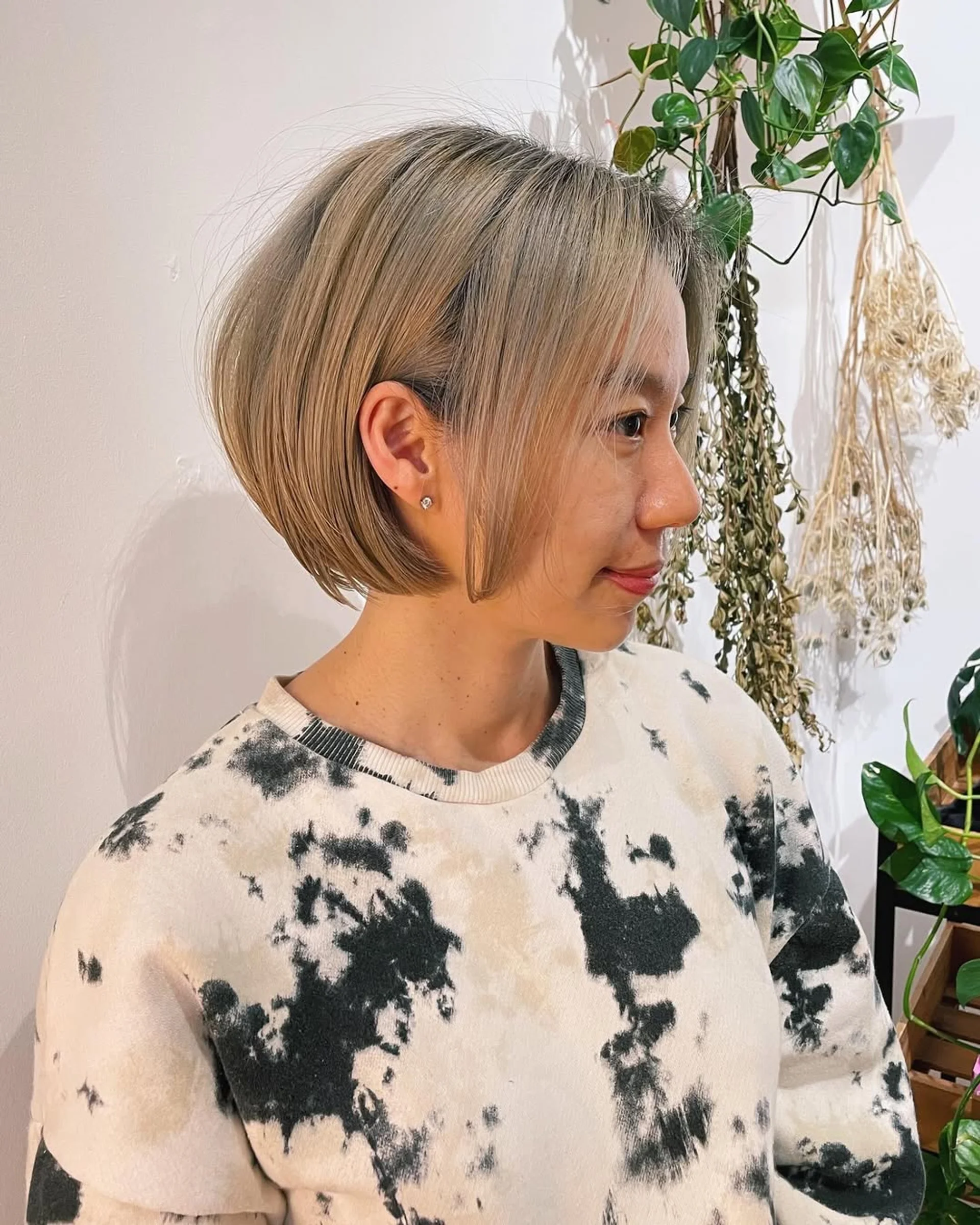 A woman with a wavy modern shag haircut featuring curtain bangs, embodying the retro-futurism trend. - Preview 3