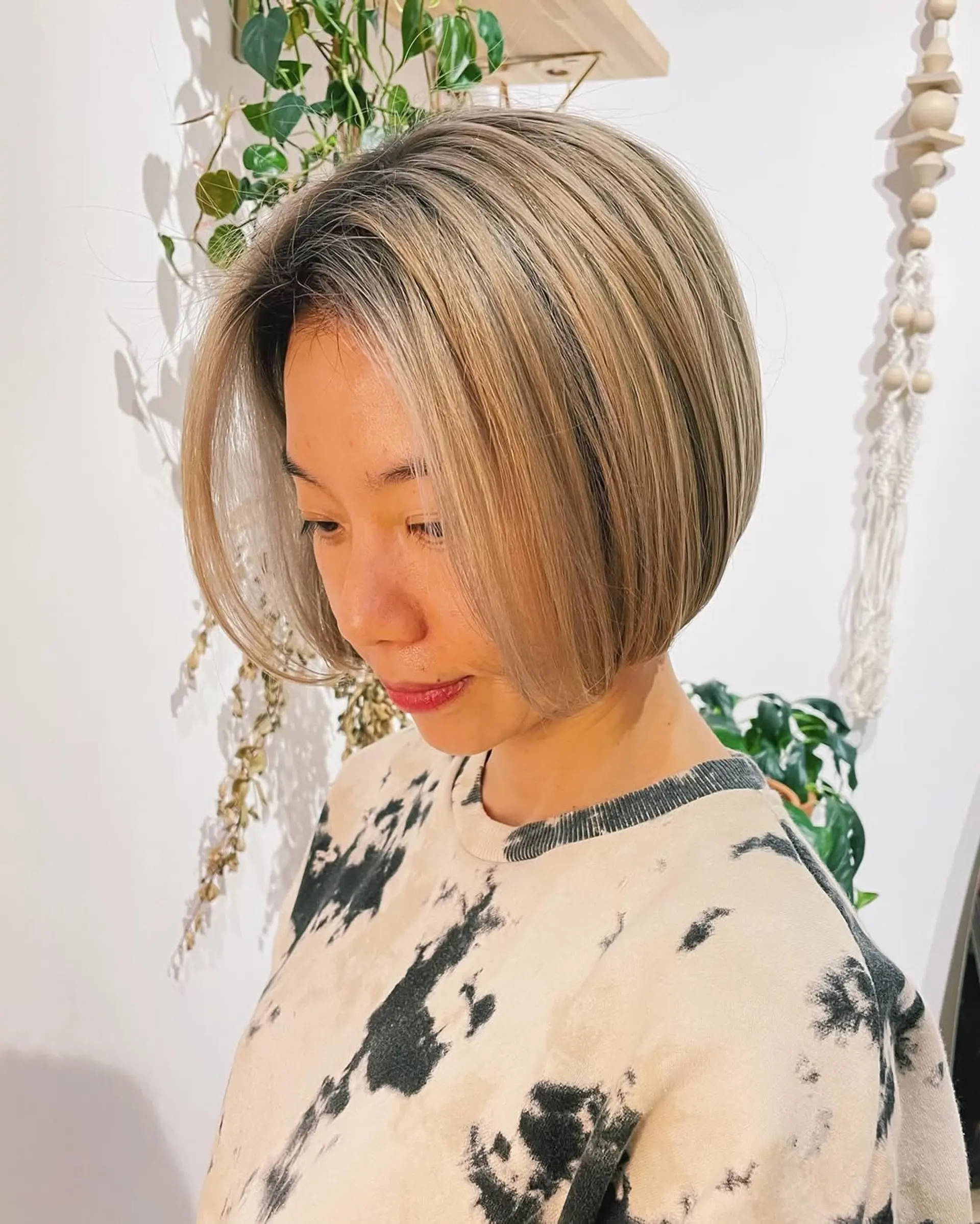 A chin-length blunt bob with subtle face-framing layers. 4