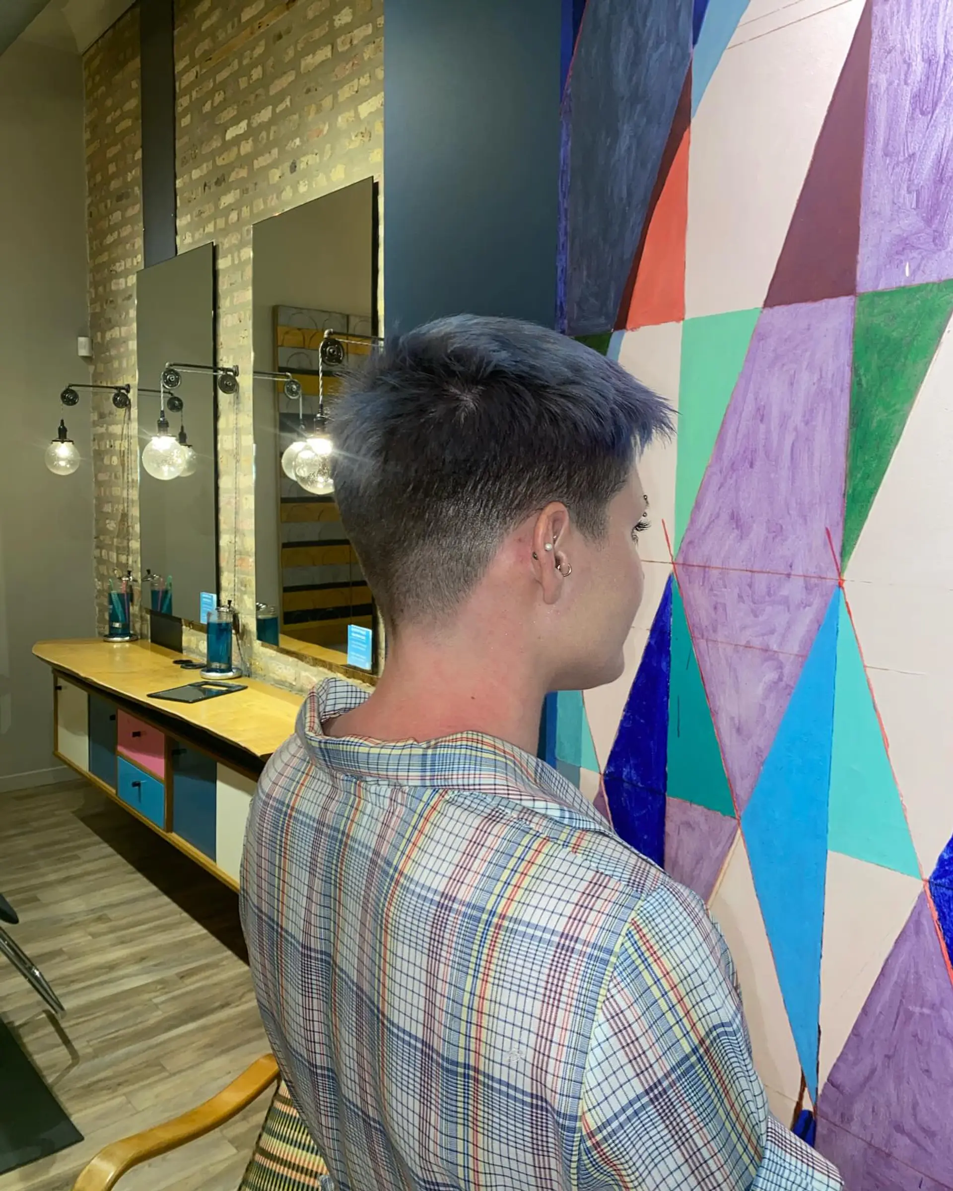 A very short buzz cut with a textured top and faded sides. 1