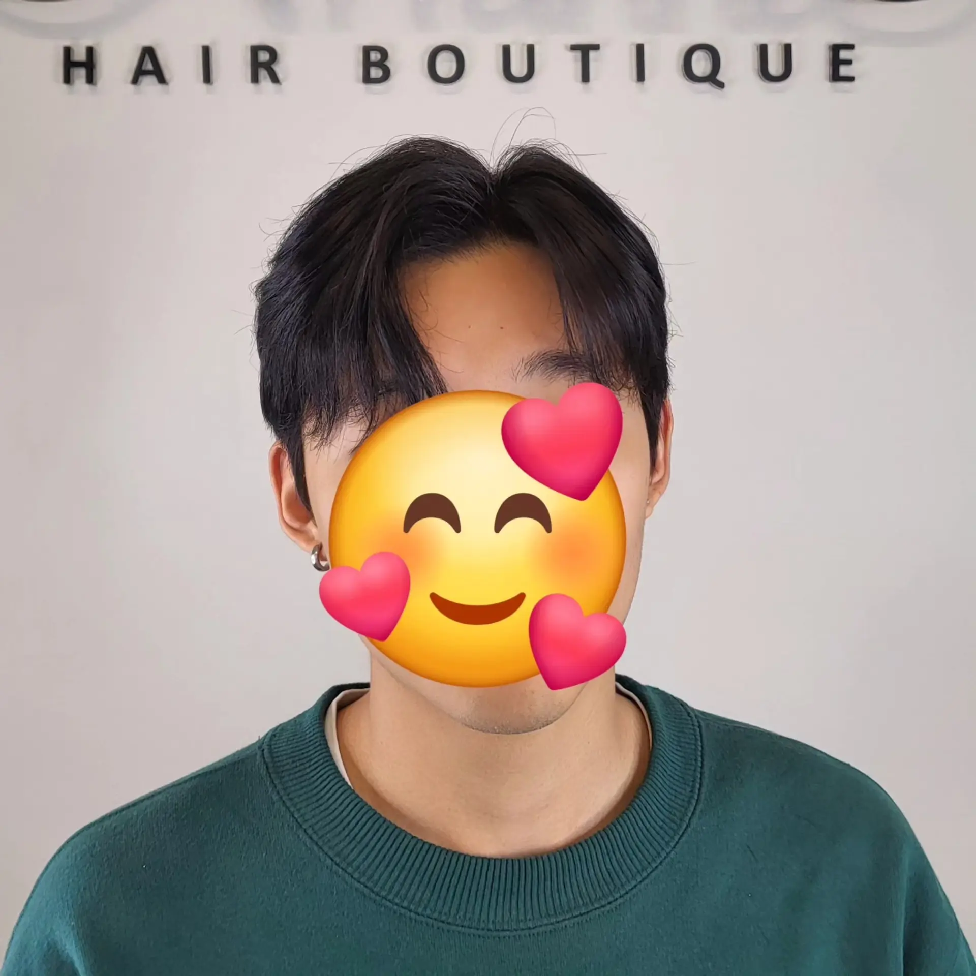 A men's short haircut styled with a center part and soft, face-framing curtain bangs. 1