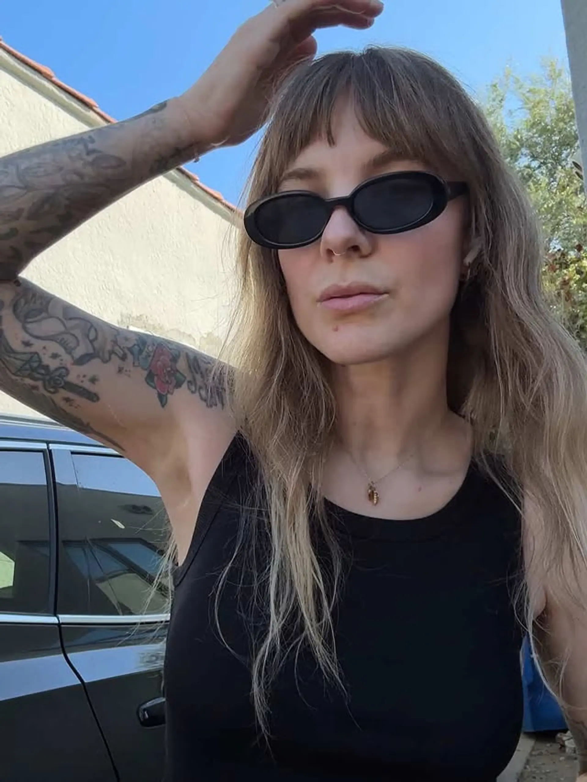 A shaggy, medium-length hairstyle with blunt bangs and textured waves. 1