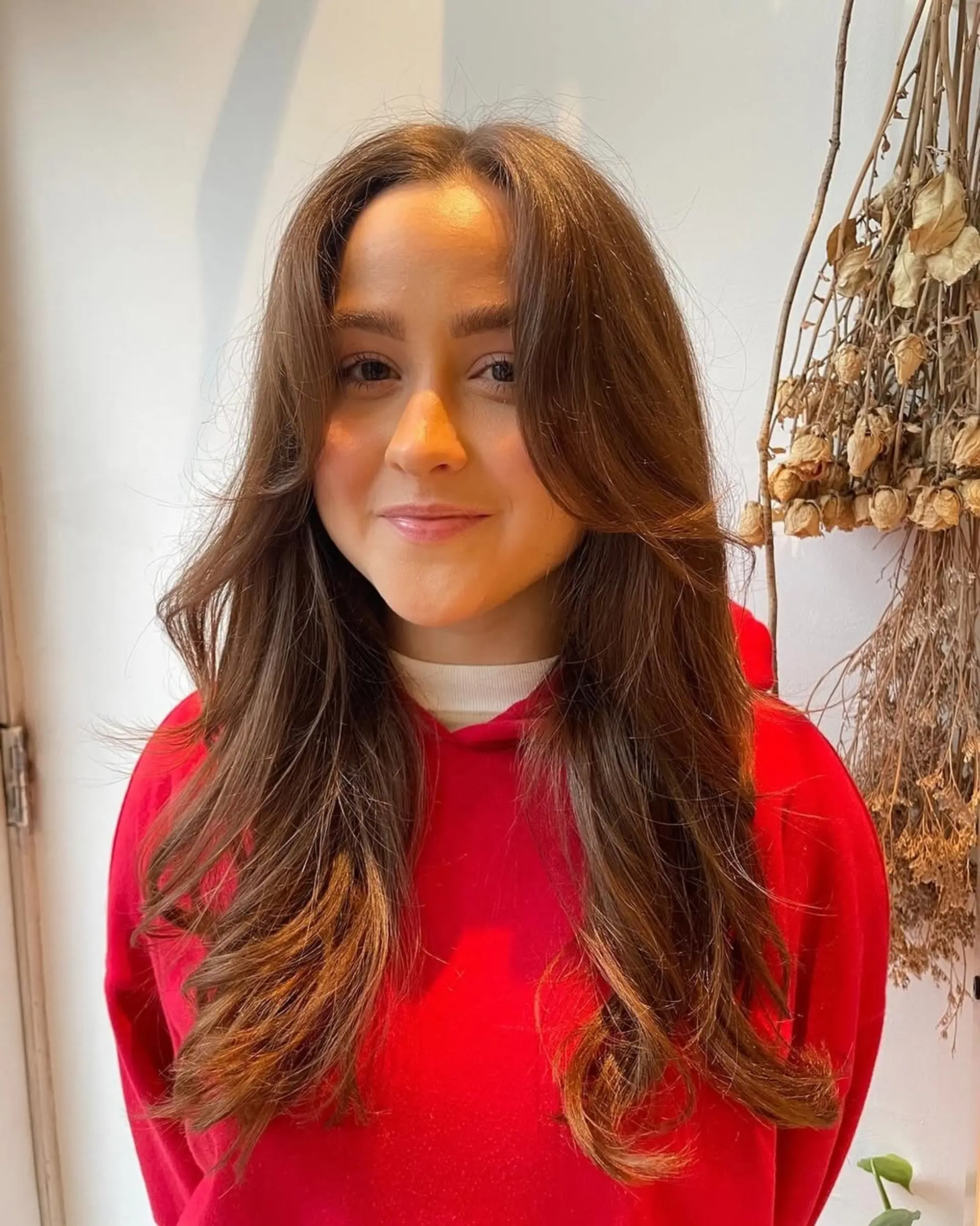 Long layered hairstyle featuring face-framing curtain bangs. 1