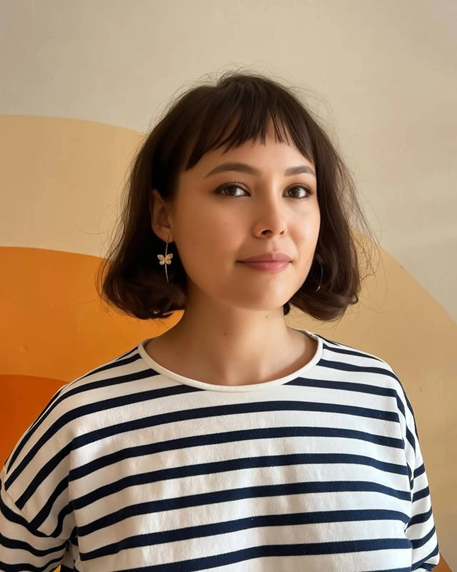 A stylish short bob with blunt baby bangs. 1