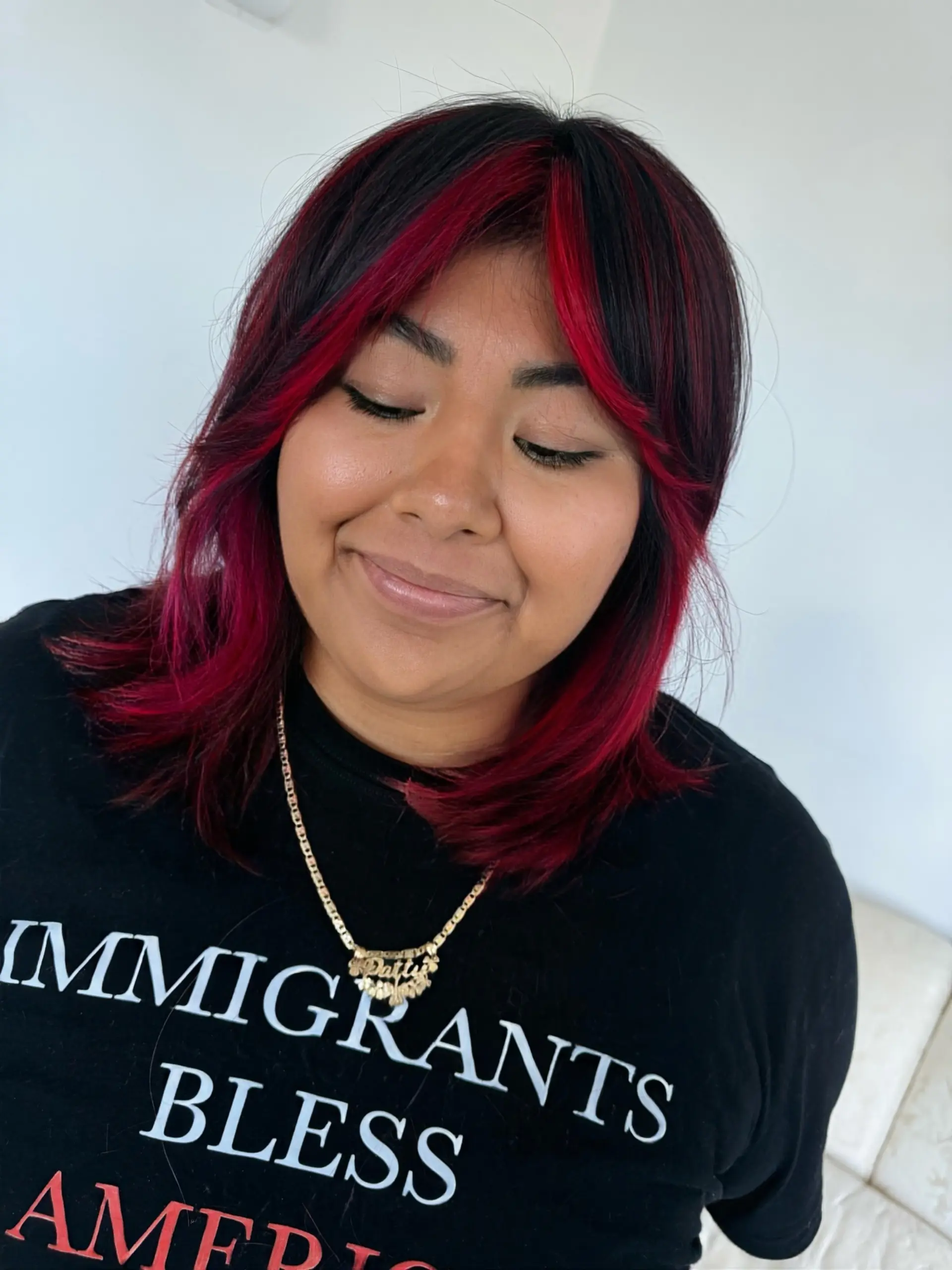 Medium-length dark hair featuring vibrant magenta face-framing highlights and curtain bangs. 1