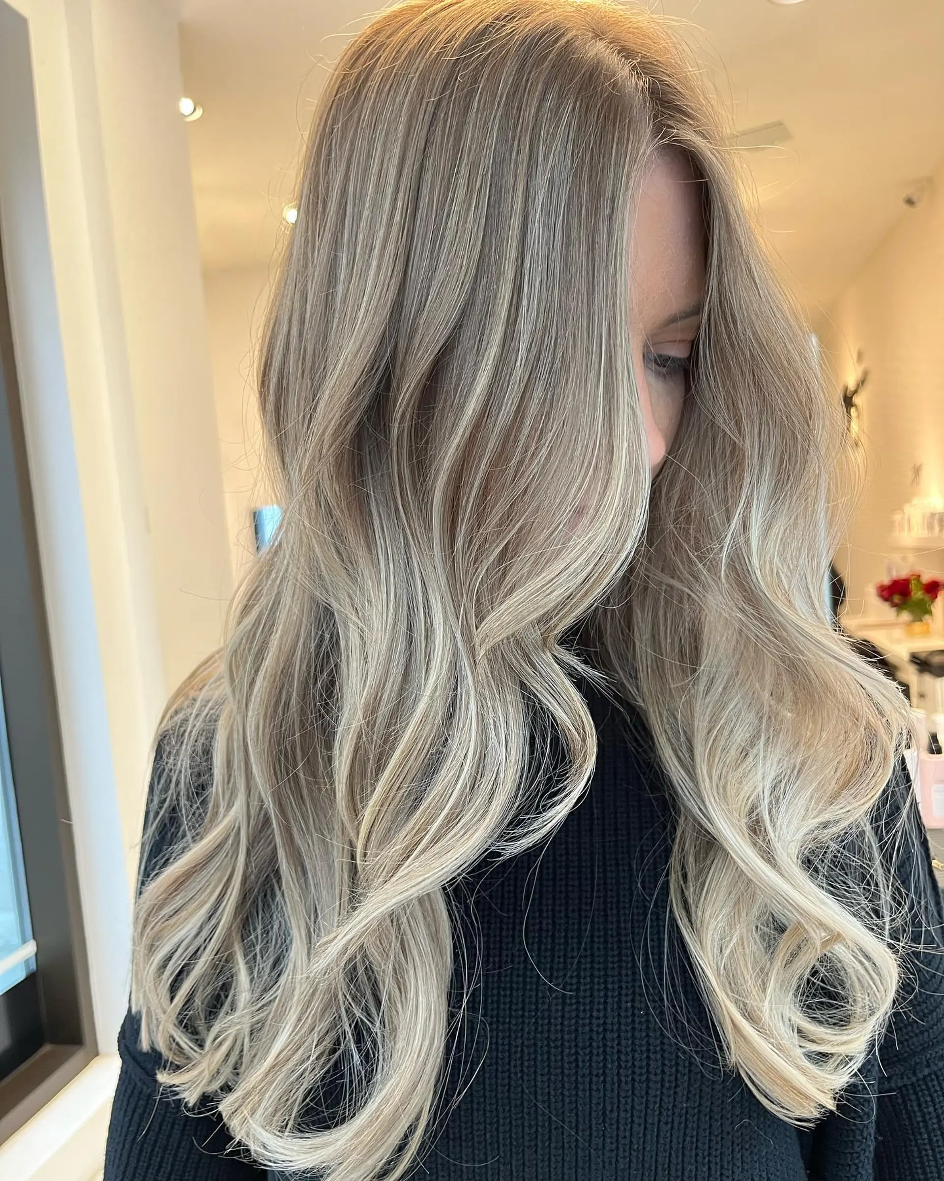Long wavy hair with a dimensional blonde balayage. 1