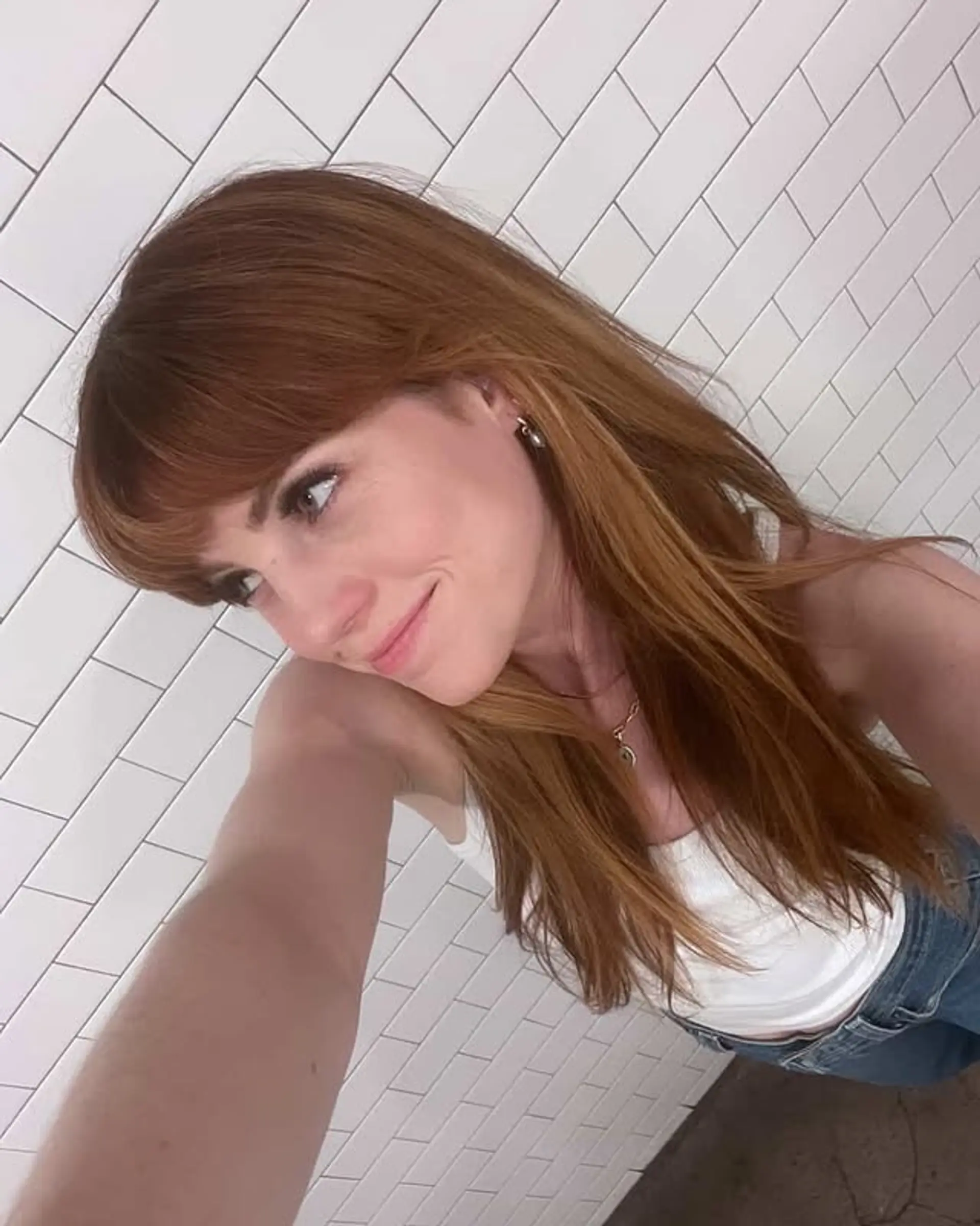 A medium-length layered hairstyle with curtain bangs. 1