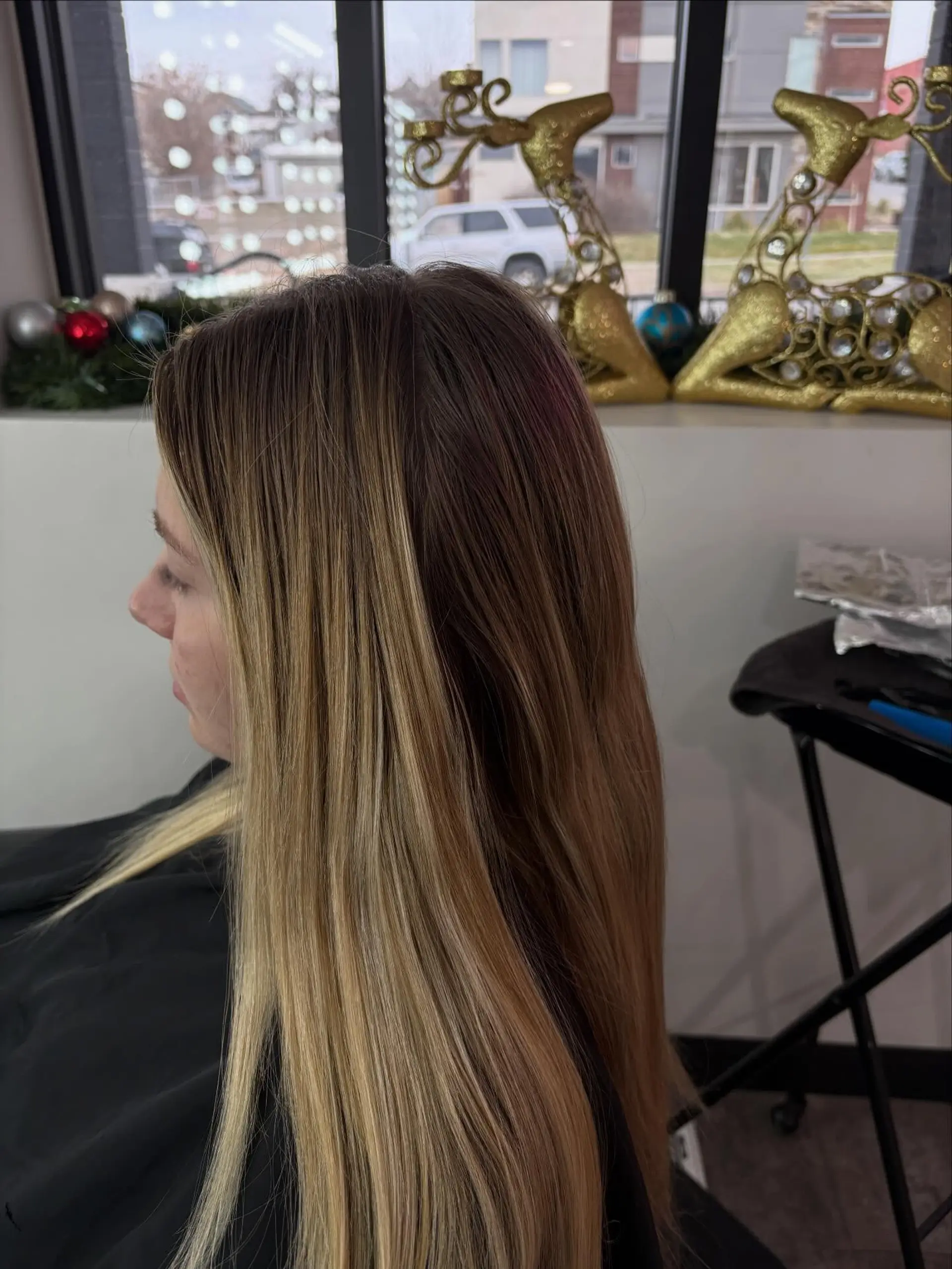 Long straight hair showcasing a lived-in blonde color melt with natural dark roots blending into bright blonde ends. 1
