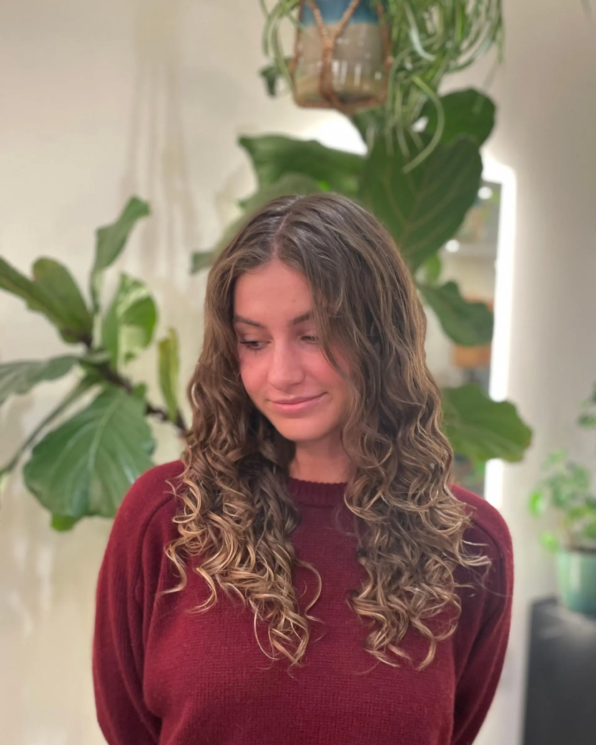 Long defined curls cut with cascading layers and soft face-framing tendrils. 1