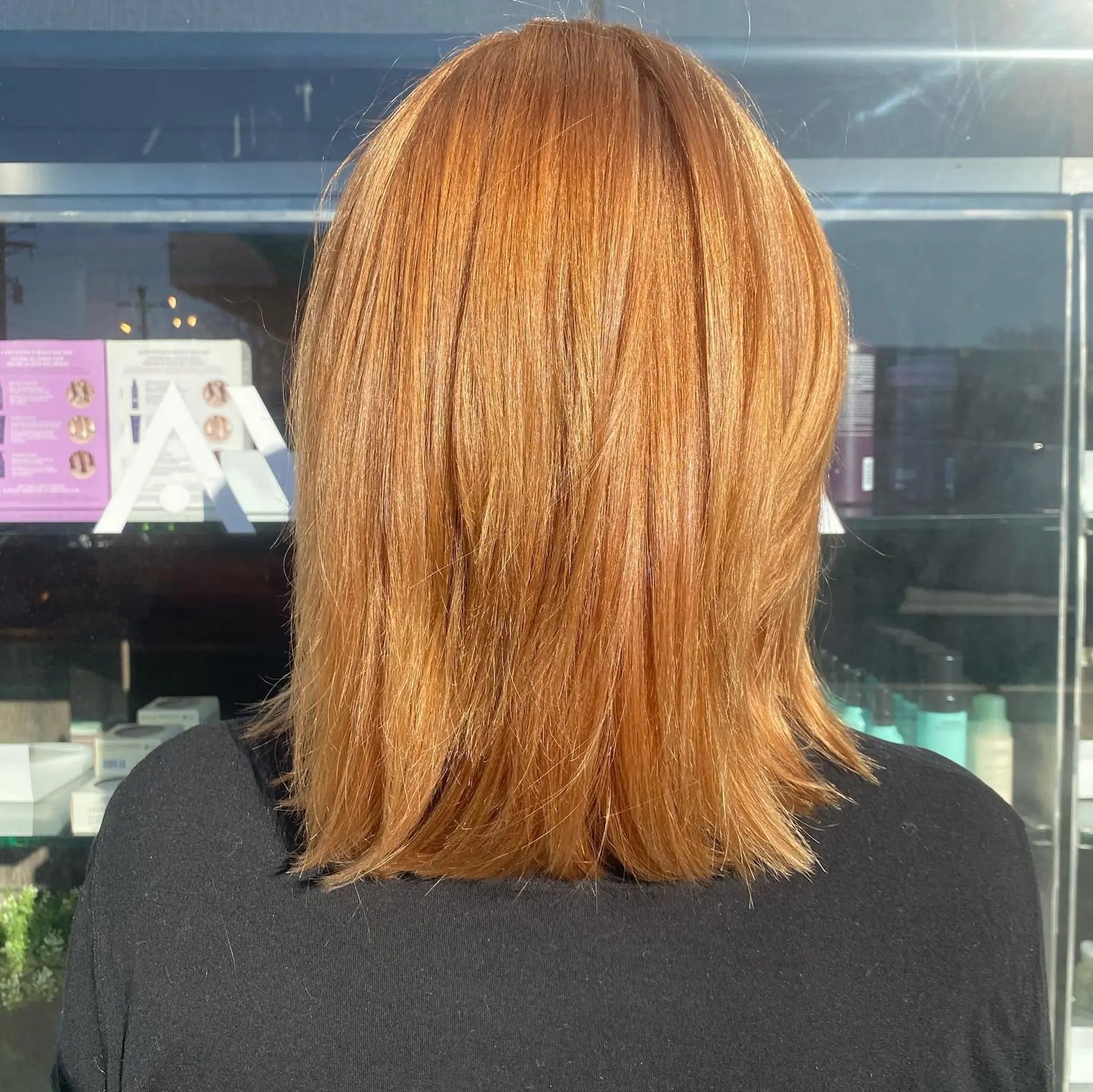 Shoulder-length straight lob styled with subtle texture and soft layers in a vibrant warm copper tone. 1