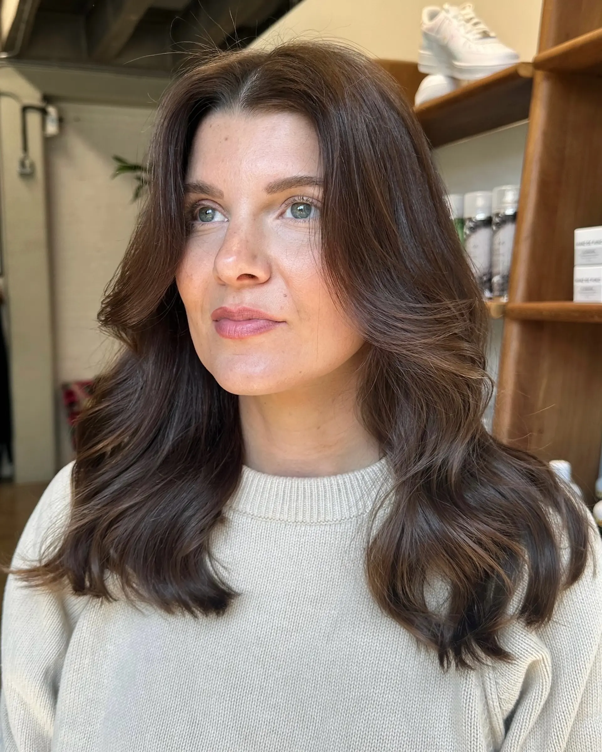 A long, layered haircut with face-framing layers and a voluminous blowout. 1