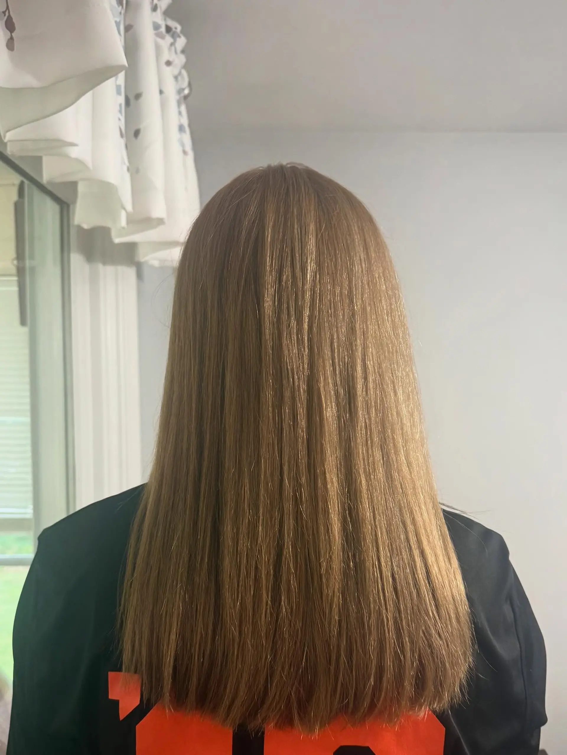 A sleek, straight long blowout featuring a clean blunt cut across the ends with a smooth, glossy finish. 1