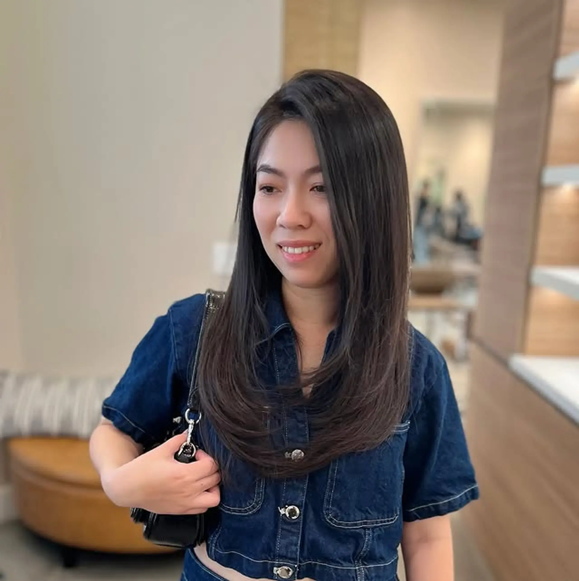 Long, layered hairstyle with soft black color for a polished look. 1