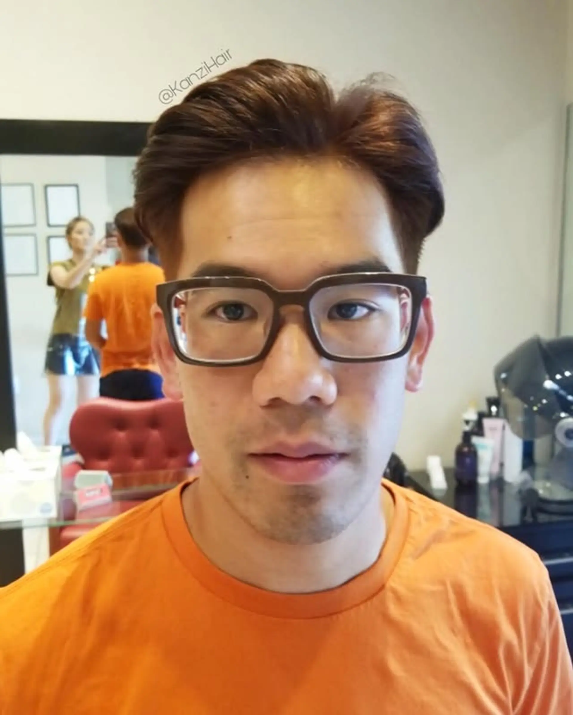 A sophisticated men's quiff with volumized, medium-length hair swept back from the forehead, featuring clean, shorter sides for a modern and polished look. 1