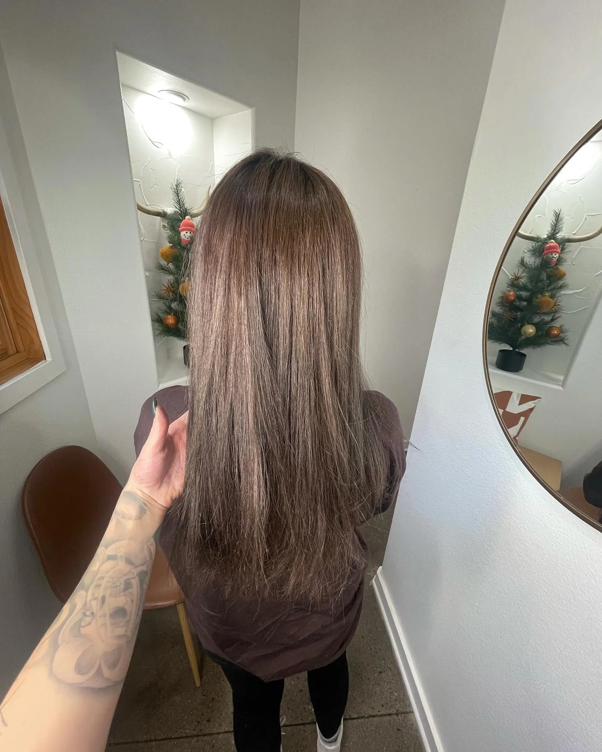 Long, straight hair colored in a cool ash brunette tone with subtle dimensional highlights. 1