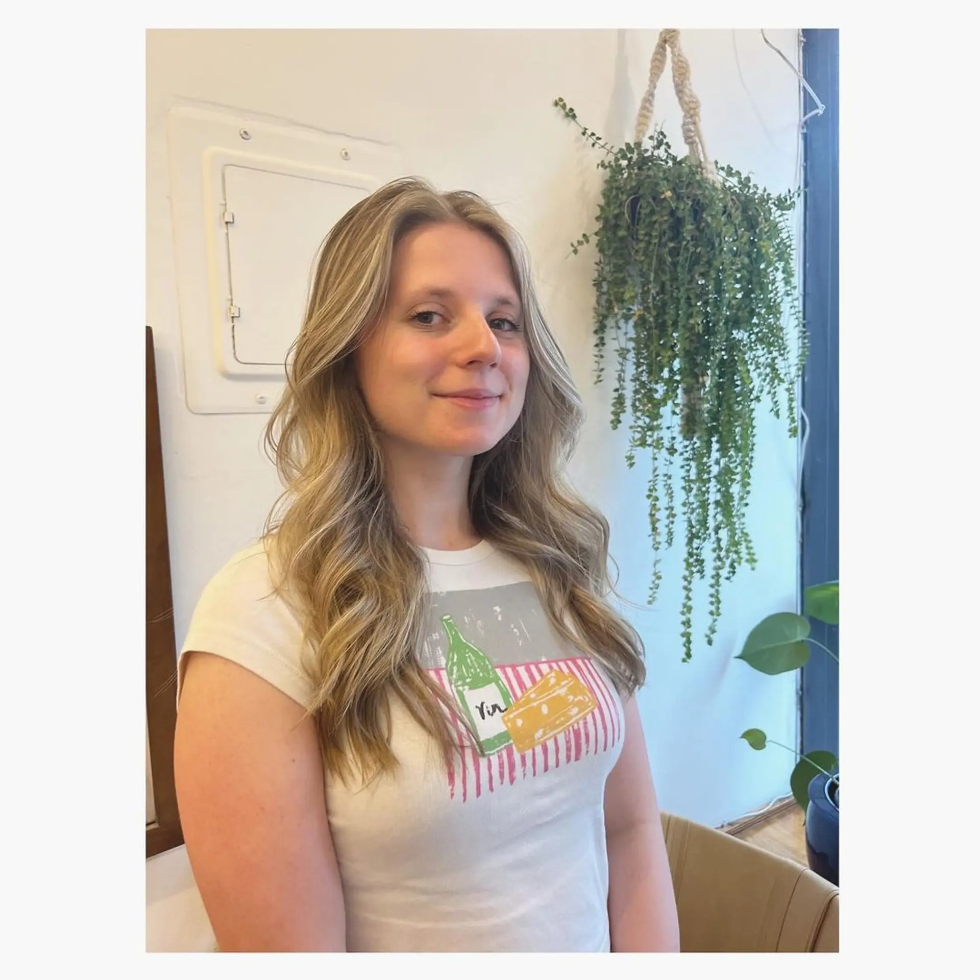 The hairstyle features long, layered waves with a soft texture and sunlit shine, blending honey blonde with golden highlights. 2