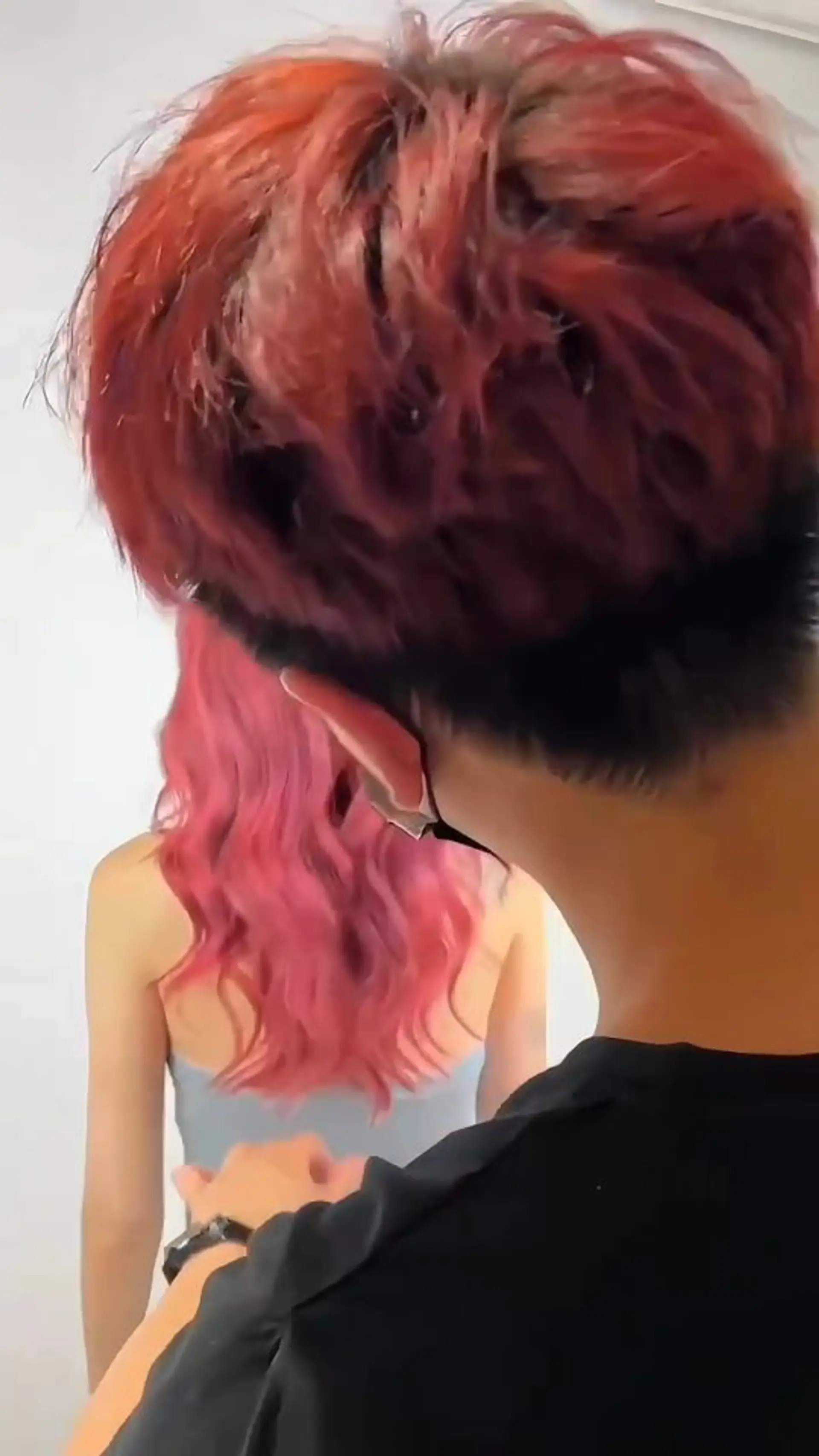 A vibrant pink hair color styled with soft, loose waves. 1