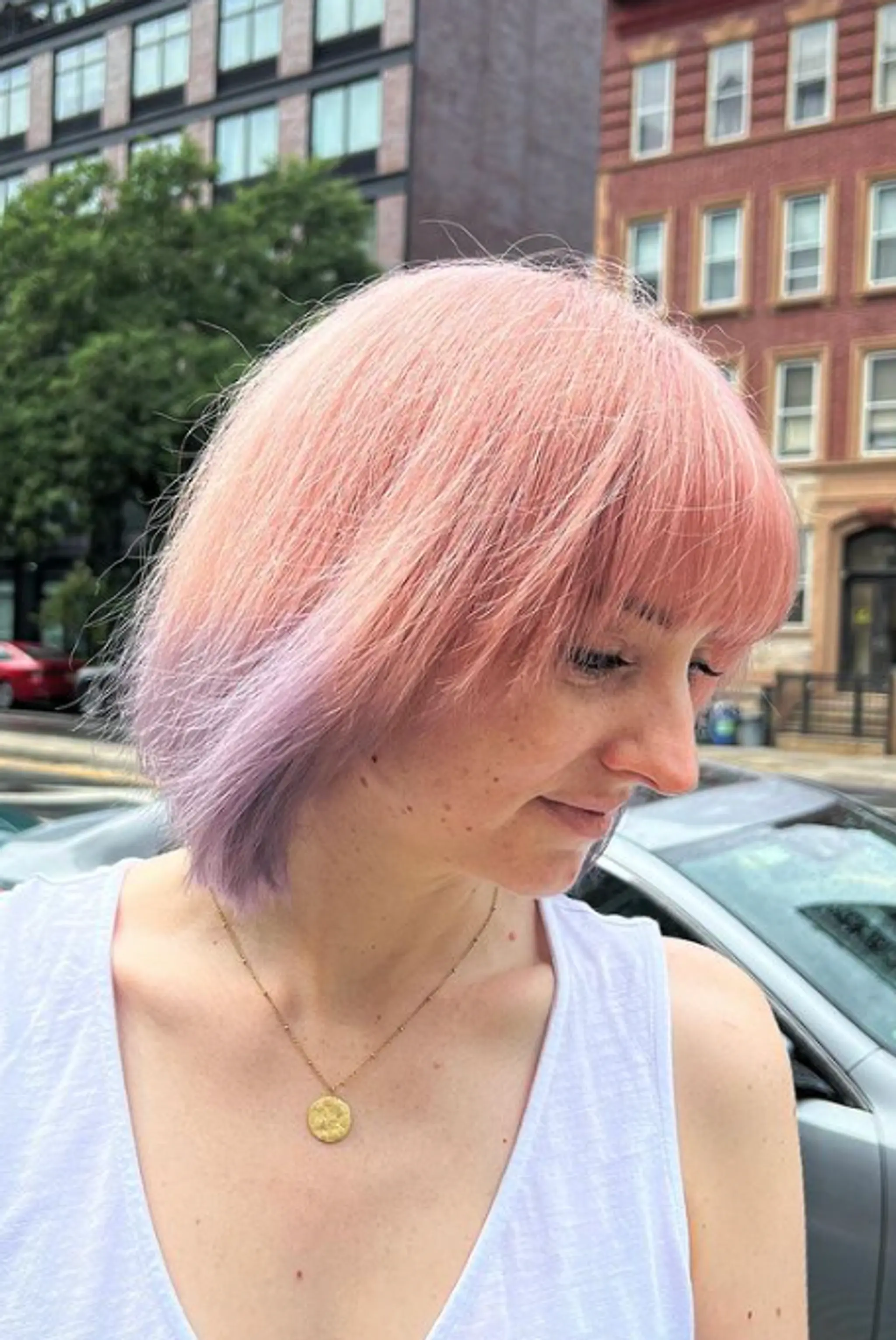 Medium-length bob with pastel pink and lavender tones, featuring straight hair with soft layers and a straight fringe.