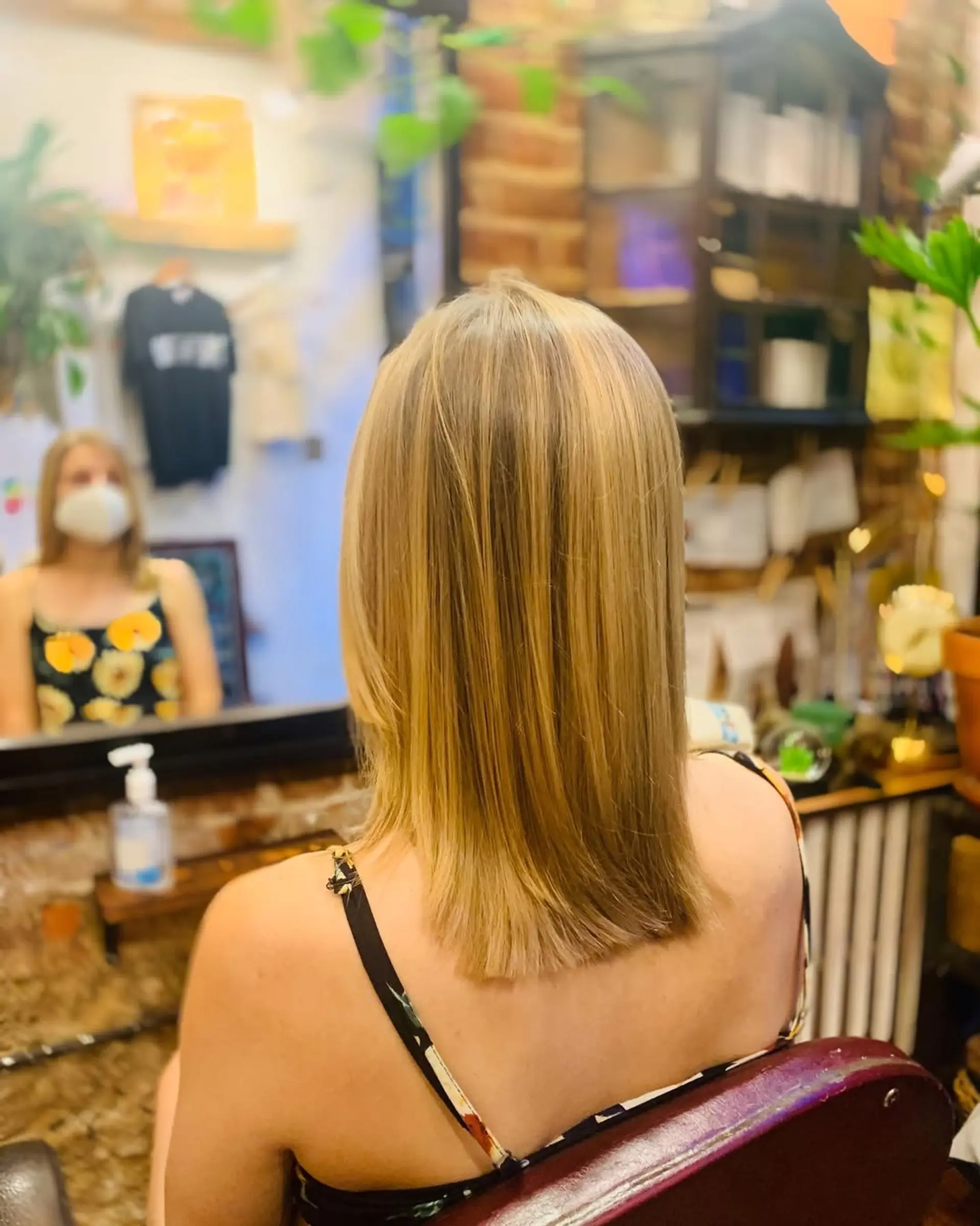 A sleek, medium-length layered cut with honey blonde highlights. 1