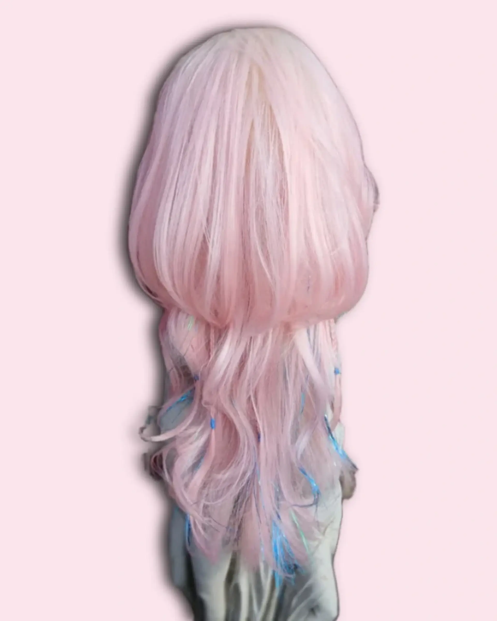 A dramatic pastel pink jellyfish haircut featuring a rounded, voluminous upper bob tier over cascading long wavy layers with subtle blue accents. 1