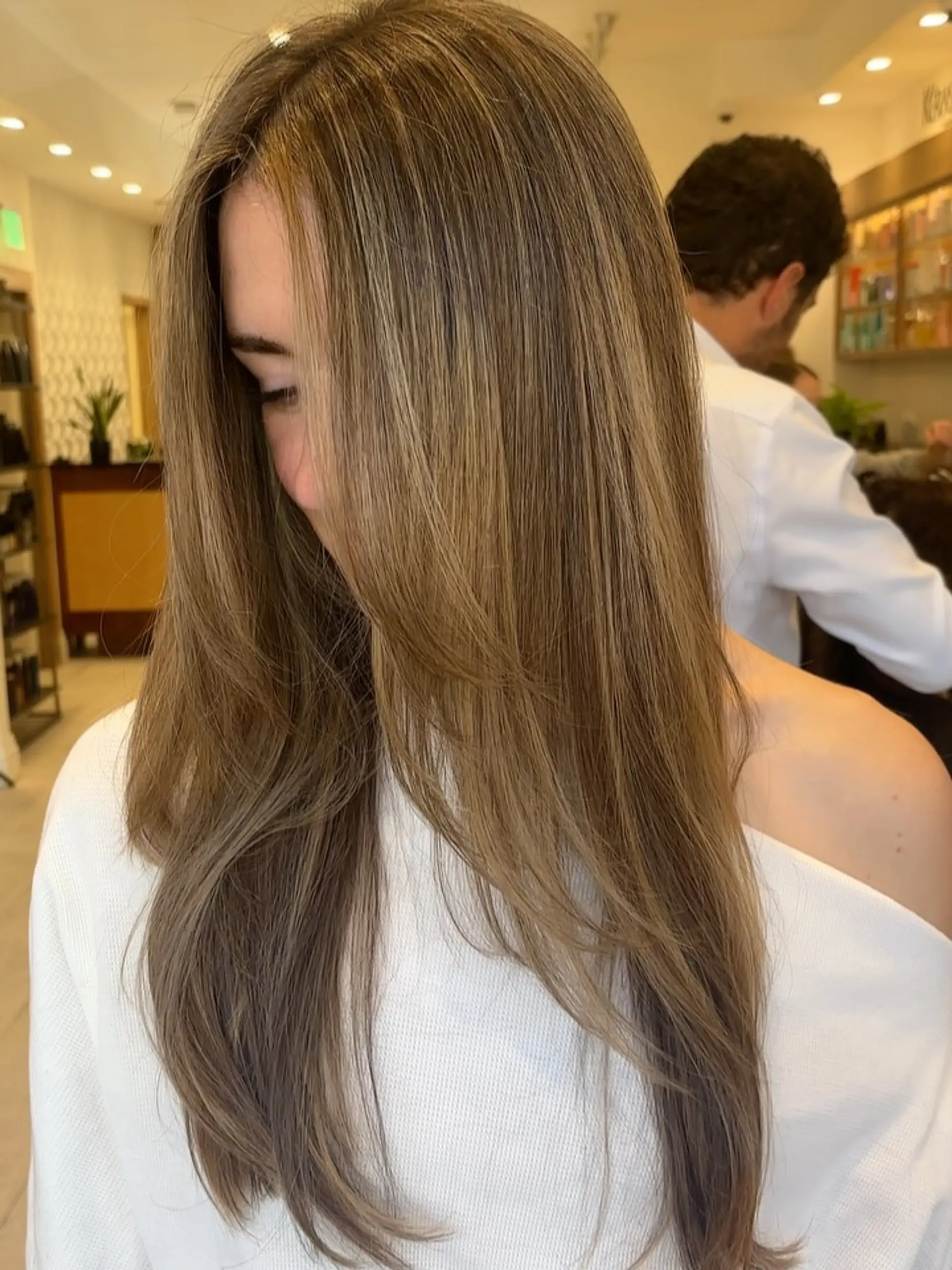 Long, smooth bronde hair featuring soft, warm highlights and long face-framing layers. 1