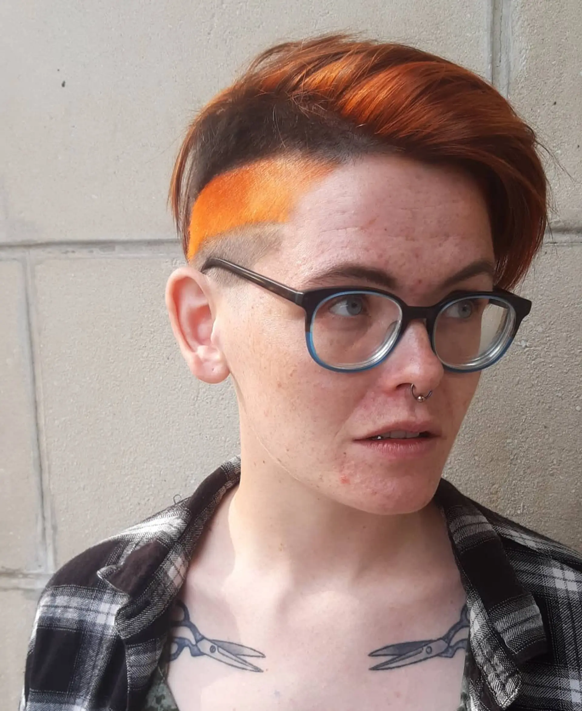A short pixie cut with an undercut and vibrant color. 1