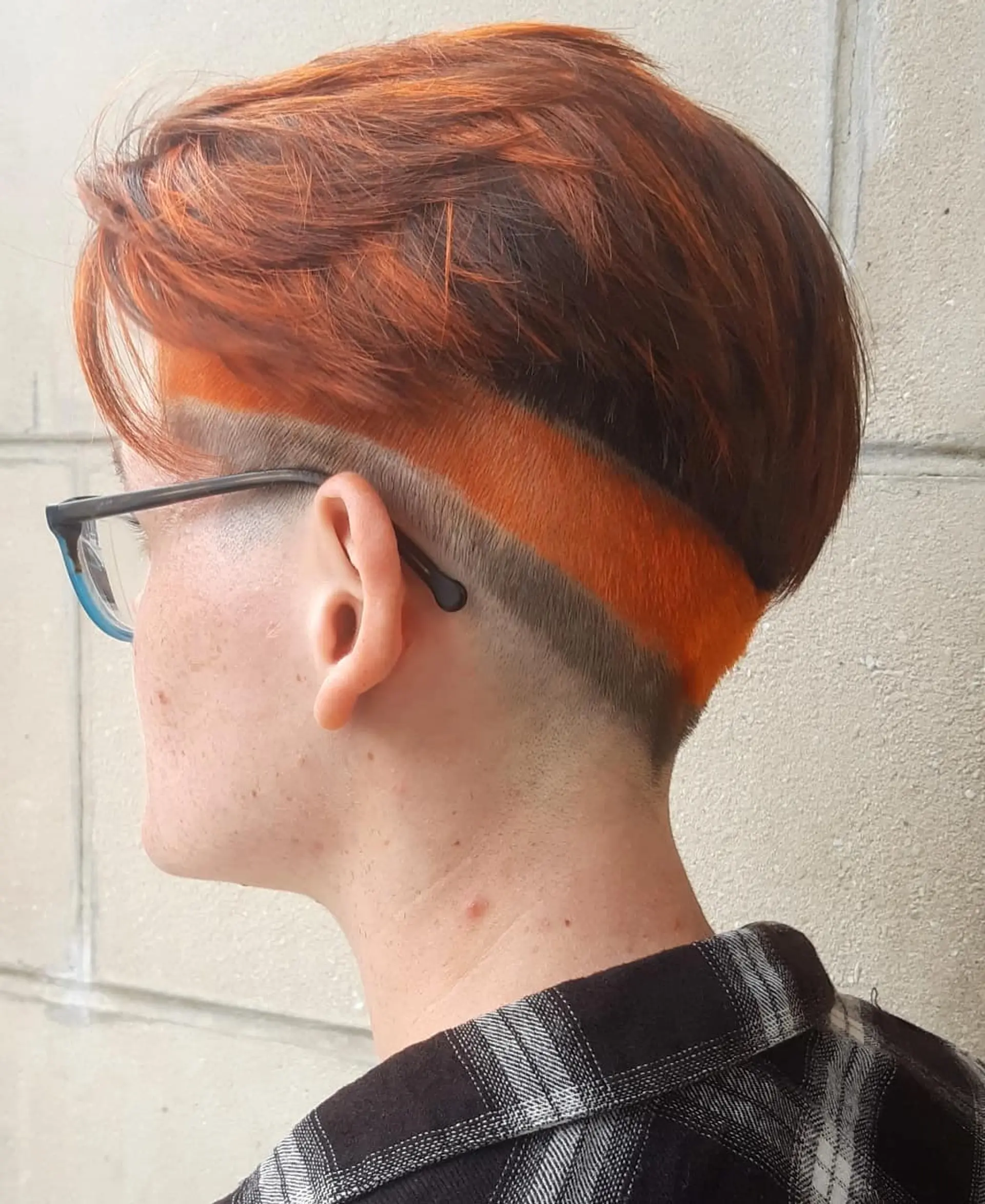 A short pixie cut with an undercut and vibrant color. 2