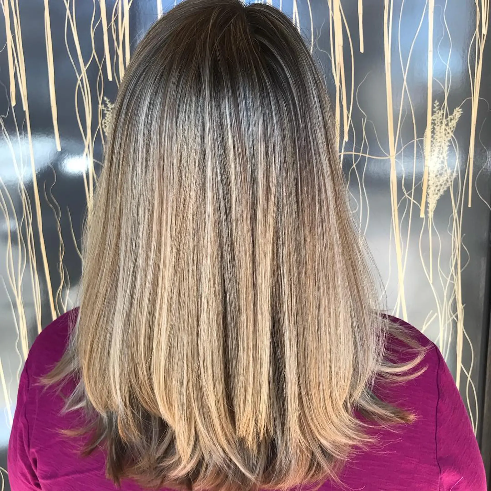 Medium-length straight hair featuring multidimensional blonde balayage and highlights layered over natural darker root tones. 1