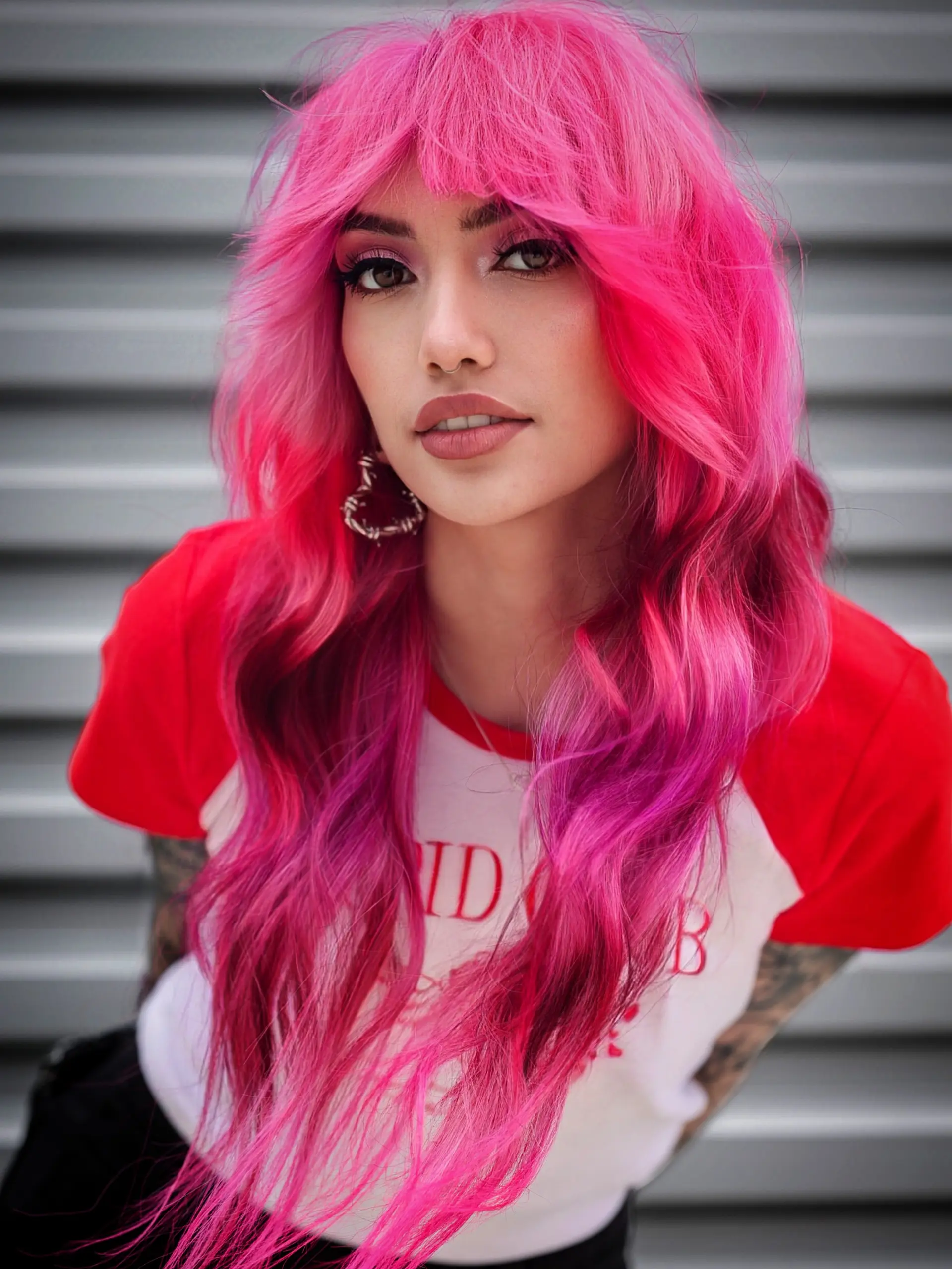 A bold, vivid hot pink long shag featuring textured full bangs and soft, face-framing waves. 1